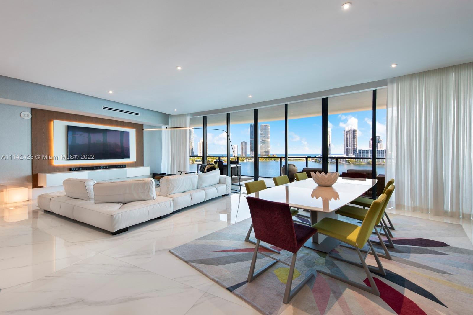 An extraordinary residence at Prive, a private, gated island north of Miami Beach in Aventura.  This sprawling 4 bedroom residence has a flow-through design, with direct, unobstructed water views on all sides, from all windows.  This designer-finished home has 60x60 Italian Touche Blanco Gris porcelain flooring and Spanish Vedani Mobili doors throughout.  A Savant whole home control system controls lighting, air conditioning, drapes, blinds, TVs and audio systems via controllers or mobile apps.  This modern, luxurious design creates one of Miami's finest residences in a full-service, amenity-rich condo that includes multiple swimming pools, a world class fitness center, onsite restaurant, 24 hour security, valet parking and more.  This residence comes with three dedicated parking spaces.