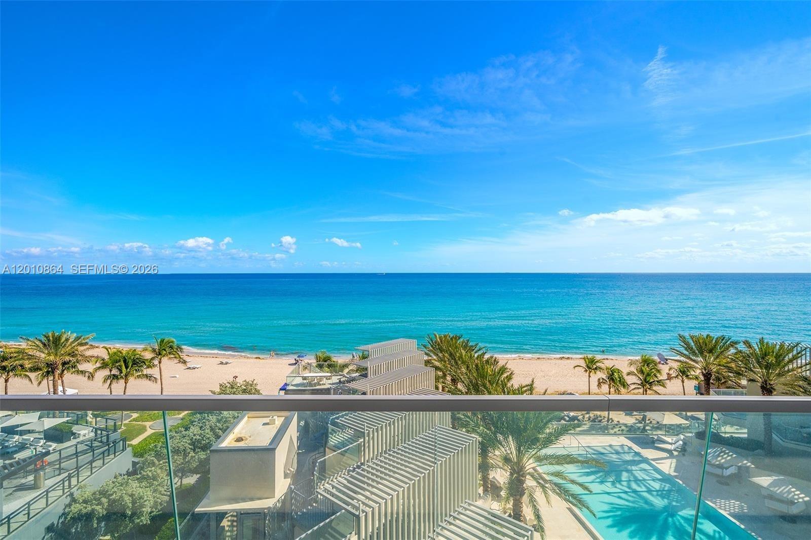 Welcome home to this bright and modern Beach Villa at Turnberry Ocean Club Residences.  Wake up to Miami's mesmerizing sunrises with the sound of the ocean. 
This exquisite villa captivates with soaring 11-foot ceilings and magnificent views of the Atlantic Ocean and Bay. Impeccably designed, it features beautiful millwork and an expansive chef's kitchen with Gaggenau appliances. The open living space floor plan extends to an oversized terrace, offering a seamless indoor-outdoor flow. With 4 bedrooms + den, 5.5 bathrooms, and dual exposure to breathtaking sunrises and sunsets, this Sky Home epitomizes sophisticated luxury. Residents enjoy exclusive access to over 70,000 SQ FT of amenities plus Turnberry's $100M Signature Sky Club, 3 pools, private cafe & dining, a wellness spa, and entertainment facilities. The world renowned lifestyle is here for your enjoyment.