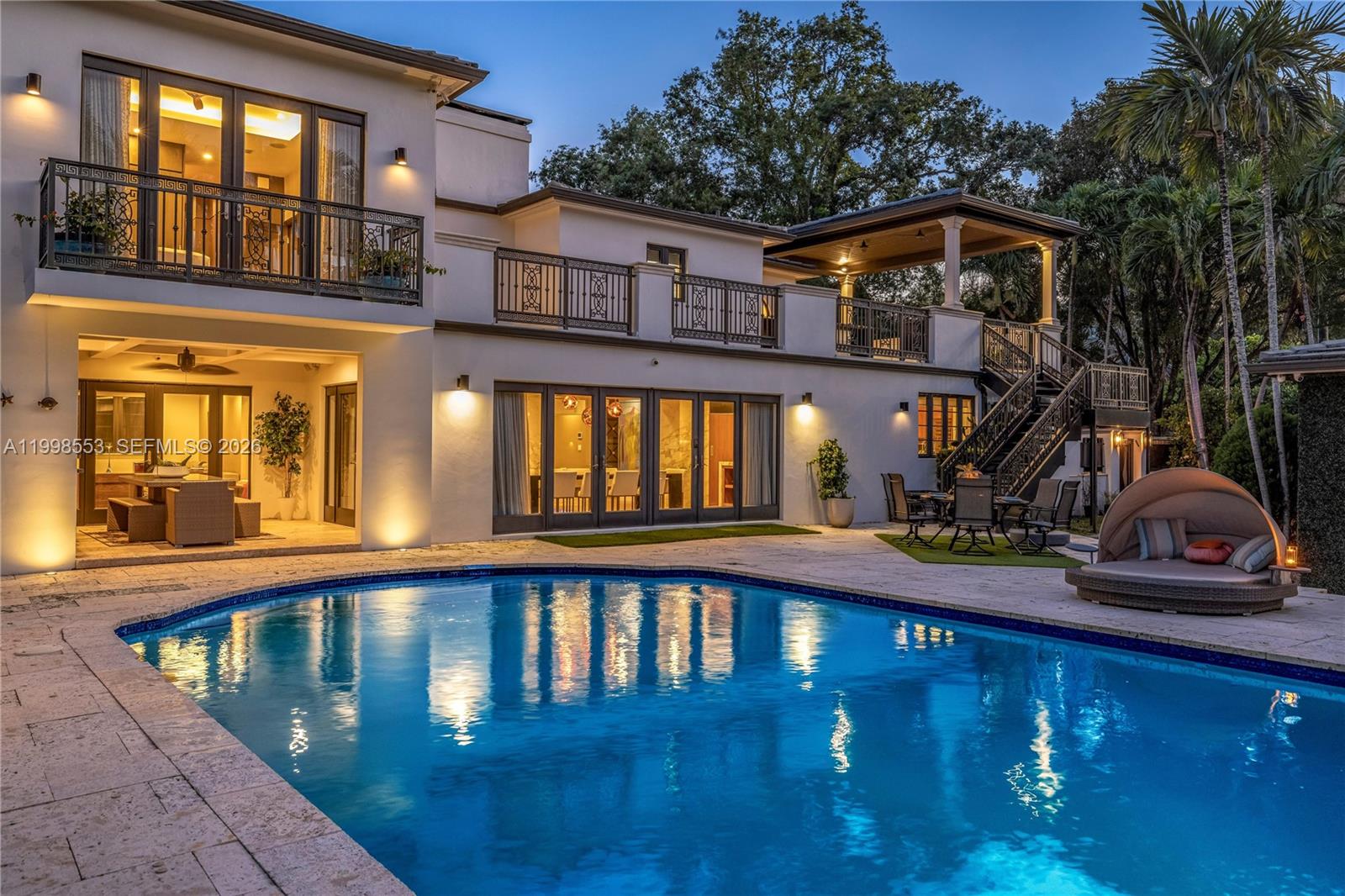 Step into a gated modern estate that delivers the ultimate blend of privacy, design, and resort-style living in one of Miami Shores’ most sought-after locations east of Biscayne. From the moment you enter, soaring ceilings, a dramatic floating marble fireplace, and a wide open layout create an immediate sense of scale and impact, all seamlessly connected to the outdoor living spaces and pool.
The chef’s kitchen is designed to impress and perform, featuring custom teak cabinetry, marble countertops, and a refined breakfast banquette that anchors the space. The primary suite offers a true retreat with grand volume, a private terrace, and a spa-inspired bath that rivals luxury hotels. The outdoor experience is where this home truly stands apart. A 50 ft pool, sauna, expansive lounge areas, and a fully equipped summer kitchen set the stage for unforgettable entertaining. Elevated above it all, a covered lounge with a full wet bar, accessible from both the exterior and second level, delivers a one of a kind vantage point and experience rarely available.



A detached 1 bedroom, 1 bathroom guest house, spacious two car garage, gated side parking, electric vehicle charging, and a Control4 smart home system complete the offering. With rare duplex zoning and a prime east of Biscayne location, this is a unique opportunity that demands to be seen in person.Residense offers gated side parking + AC garage with electric charging station + Control 4 Smart system for the entire home.