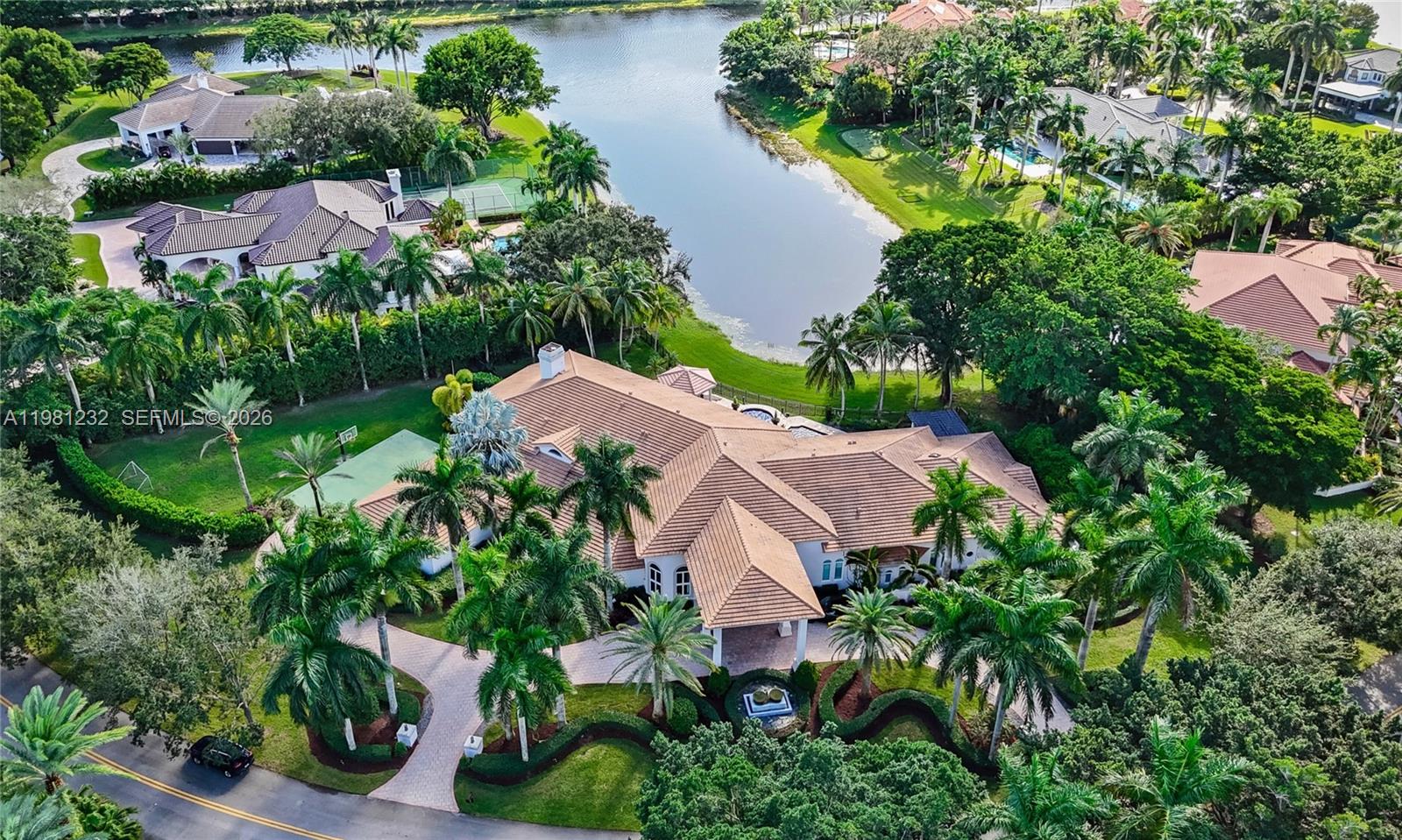 Fully reimagined lakefront estate in the prestigious community of Windmill Ranch Estates in Weston. Situated on a sprawling 1.5-acre lot, this exceptional residence offers a newer roof, approximately 8,000 SF of living space with 6 beds, 8 baths, 1 half bath, and a private office, a home theater, and a billiard room with a custom bar. A spectacular grand entry opens to the main living areas with panoramic views of the pool and tranquil lake. The split floor plan is ideal for entertaining while maintaining privacy. The entertainer’s wing features a custom home theater (easily convertible to a 7th ensuite bedroom) and a billiard room with bar. The open modern kitchen showcases top-of-the-line appliances, including three Infinity Pro wine coolers, and beautiful lake views. Marble flooring enhances the main social areas, while laminate floors add warmth to the bedrooms. The expansive primary suite features stunning water views, a large sitting area, and access to an outdoor seating space. The resort-style backyard features unobstructed lake views, a large pool and spa with waterfall features, a swim-up bar, a sunken gazebo with BBQ, and a fully equipped summer kitchen. Professionally landscaped grounds with manicured hedges and tall palms enhance the estate’s privacy and elegance. Interior and exterior Sonos sound system. Located in one of Weston’s most sought-after communities.