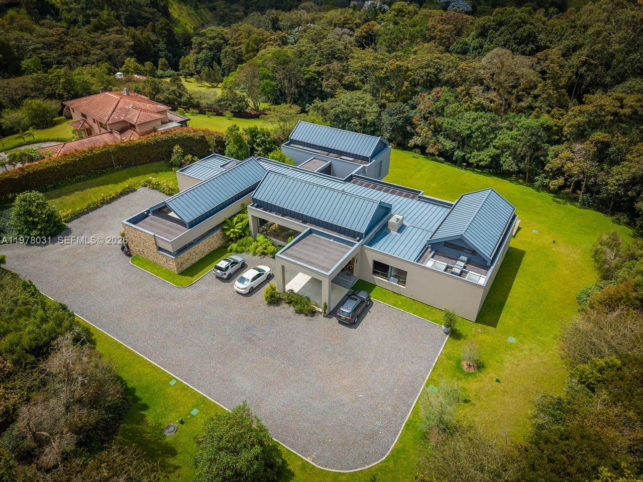Elegant residence ideally located in Envigado, within the Medellín metropolitan area, Colombia, in the prestigious “Arroyanes Country Club”. This exceptional property offers approximately 10,333 square feet (960 m²) of living space, set on a generous 1.7-acre lot (6,900 m²), providing privacy, space, and a serene natural environment.

Medellín, internationally recognized as the “city of eternal spring,” offers a year-round mild climate, world-class infrastructure, and an outstanding quality of life. The property is conveniently situated approximately 30 minutes from José María Córdova International Airport, with direct connections to Fort Lauderdale, New York, and other major U.S. destinations. Positioned just a three-hour flight from Miami, this residence presents a compelling opportunity as a second home, international retreat, or long-term investment. It combines natural beauty, strategic connectivity, and a vibrant cultural scene, making it highly attractive for both lifestyle buyers and global investors.