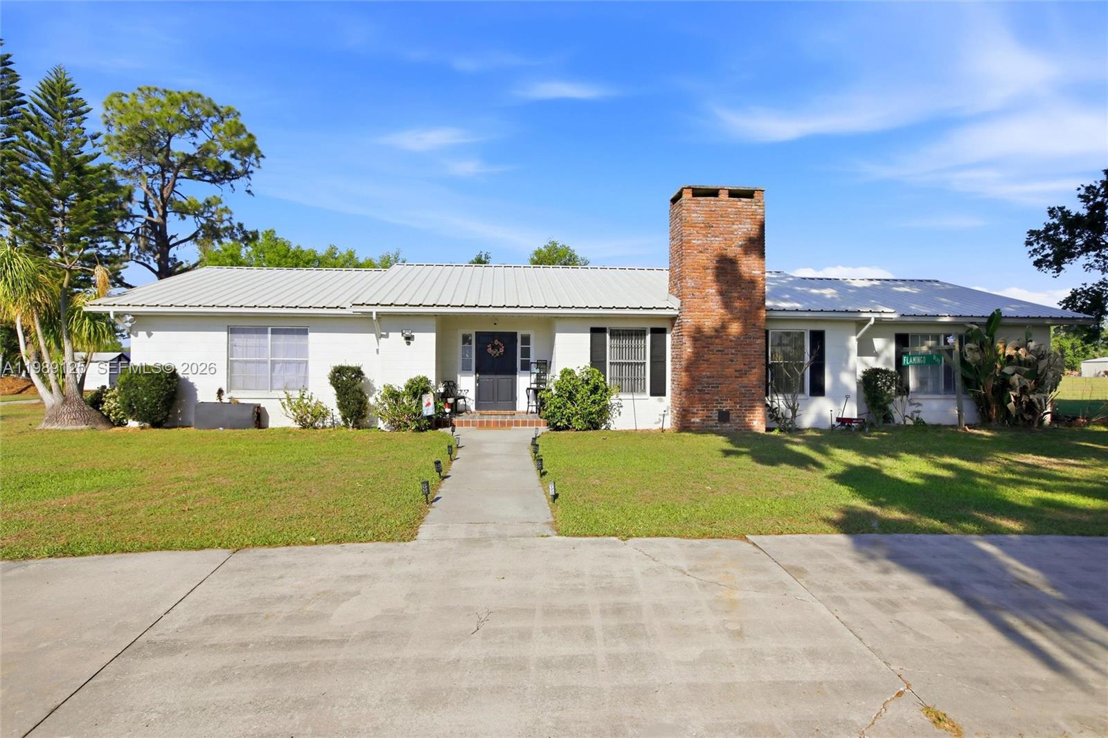 Tucked away on 1.25 private acres in peaceful Bowling Green, this well-maintained 3-bedroom, 2-bath single-level home offers the perfect blend of charm, space, and privacy. A circular driveway welcomes you home, setting the tone for this inviting property. Step inside to a warm and welcoming living room featuring exposed beams, a cozy fireplace, and an abundance of natural light. The spacious layout continues into a large eat-in kitchen, ideal for everyday living, along with a generous formal dining area perfect for hosting family and friends. The primary suite offers a comfortable retreat with its own en-suite bath, while two additional bedrooms provide plenty of space for guests or a home office. A large laundry room with utility sink adds convenience, and the attached one-car garage offers additional storage. Enjoy Florida living at its best from the screened porch overlooking a huge fenced yard—perfect for pets, play, or simply relaxing in your own private setting. Cool off in the inground pool and take in the quiet, peaceful surroundings that make this property truly special. If you’ve been searching for space, privacy, and charm—all on one level—this is the one to see!