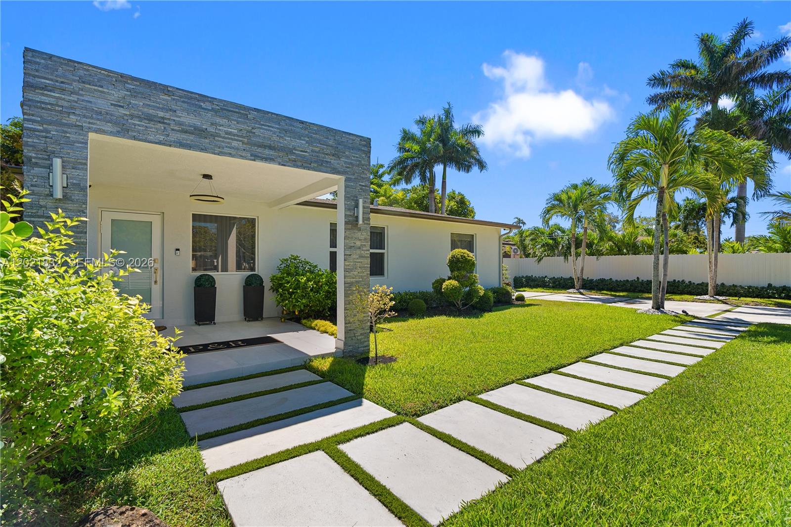 Experience a serene waterfront retreat where modern luxury meets Miami living. Set along the Biscayne Canal with access to the north lake and Biscayne park to the south for watersports fun, this fully gutted and rebuilt 3BD/2BA contemporary home offers 1,640 SF of refined comfort on a lush, fenced lot with an electric front gate. Inside, porcelain floors flow through an open layout with a sleek modern kitchen, updated bedrooms and baths, and a third bedroom with private access. Outdoors, enjoy a tranquil oasis with a new heated pool and jacuzzi, covered patio, gazebo, summer kitchen, solar-powered LED lighting, and beautiful water views from the patio and primary suite. With impact windows, security system, a newer 2020 roof, brand new plumbing and electrical installation, no HOA, and turnkey appeal, this rare waterfront property delivers privacy, elegance, and effortless indoor-outdoor living. Schedule your private tour today, and you will fall in love to it.