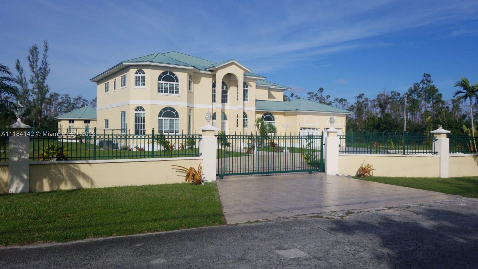 Furnished 5/5 1/2 5000 sq ft with Swimming pool, completely enclosed and gated home. Once pass gate, drive around circular driveway as the waterfall welcomes you. Cedar Ceiling embraces from entrance to get a true island feel. Come through unique tropically etched French doors. 30ft high cedar ceilings greet you as you enter and throughout with Chandeliers and high hat lights. Pass through the foyer gold/platinum columns to get to your tranquil oasis. Dining room has etched french doors, crown molding surrounds ceiling giving a spectacular view of the pool. Intercom system throughout. Master bed has upgraded gold faucets, dual marble sinks, other bathrooms have corian countertops, Lucayan International School 2 miles away for Elementary, Middle and High School.
