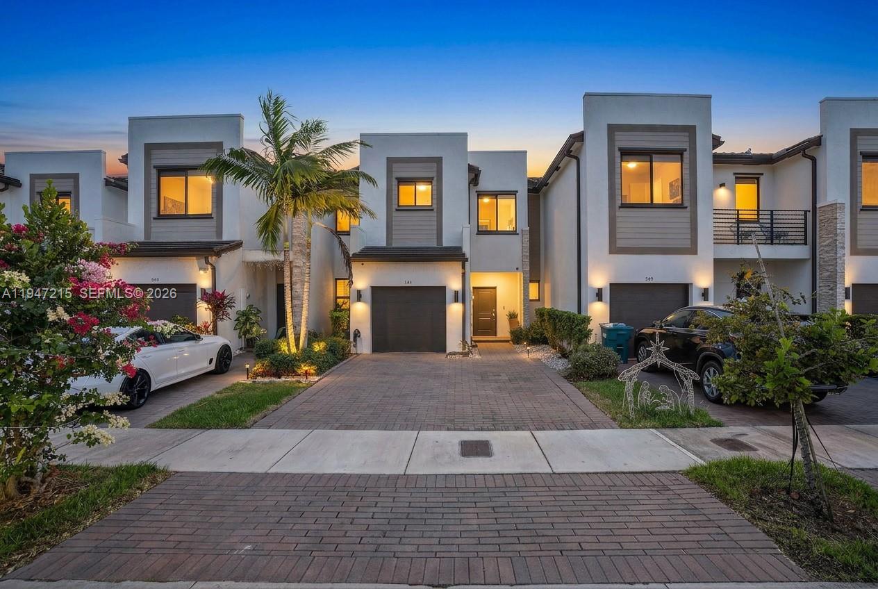 Wake up to lake views every morning in this stunning 2021-built townhouse nestled inside Paseos Via Ventura, one of Miami's newest gated communities with resort-style amenities. The private outdoor space is truly one of a kind: turf, pergola, outdoor fans, wood planking, and a direct lake view that makes every evening feel like a retreat. Inside, no detail was overlooked - quartz waterfall island, electric fireplace, updated lighting, tile, and vinyl wood flooring throughout, and an upgraded washer/dryer. The attached garage and low-maintenance lifestyle make this an easy yes for the discerning buyer. Less than 1 mile to groceries, under 2 miles to I-95, and 3 miles to Aventura Mall. The community HOA includes pool, gym, clubhouse, business center, BBQ area, children's play area, and 24/7 security - resort living at a fraction of the cost. This one checks every box. Schedule your private showing today.