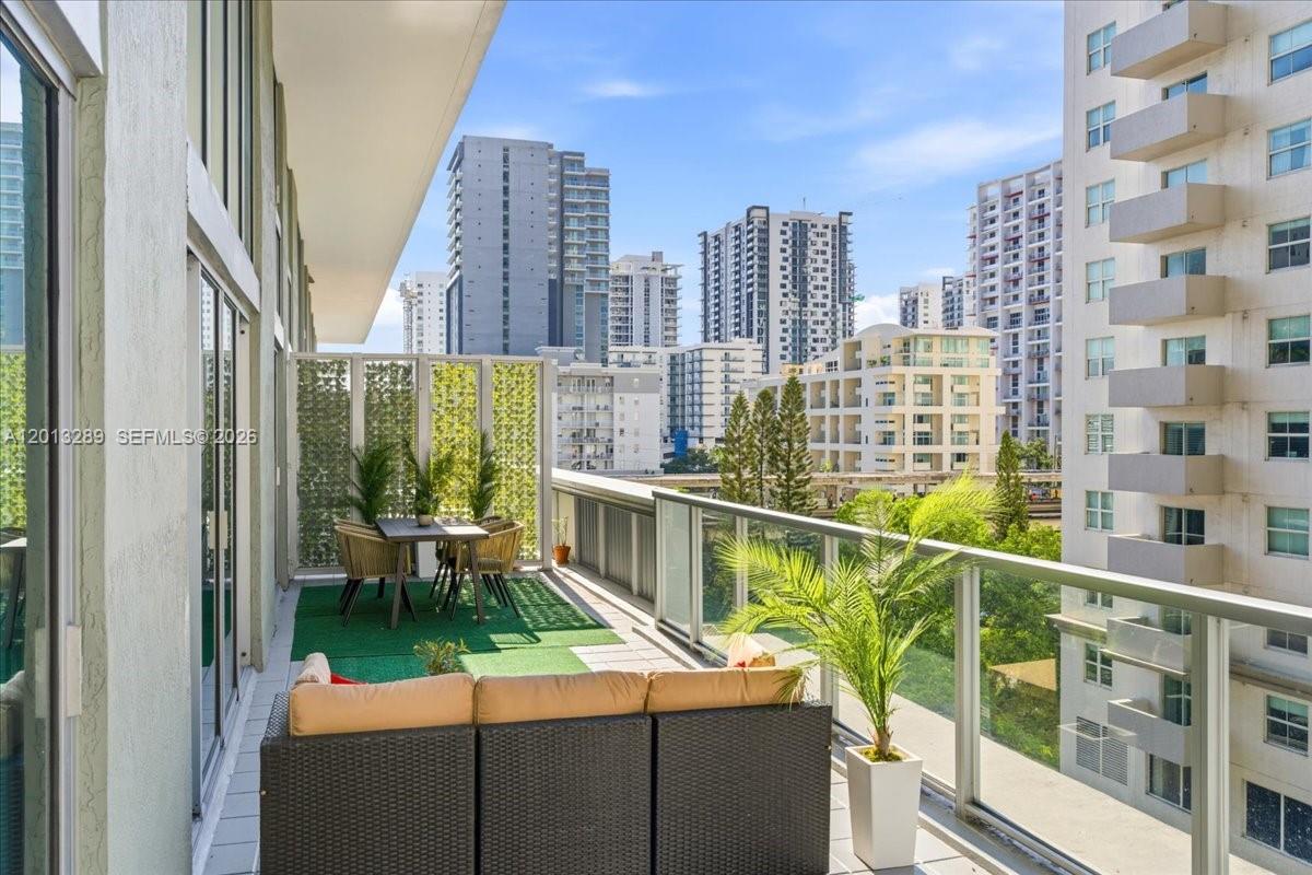 Rarely available, best priced, one-of-a-kind bi-level townhome that lives like a single-family home while offering the comfort & enjoyment of condo amenities—only 5 similar units in the building. Nearly 2,000 SF of interior space plus a 400+ SF expansive private terrace, perfect for relaxing or entertaining. The main level flows seamlessly outdoors, creating exceptional indoor-outdoor living with one bedroom and bathroom. Enjoy soaring 18-ft ceilings, floor-to-ceiling windows, and abundant natural light. Sleek upgraded kitchen with deep island, extra cabinetry, and newer appliances. Includes 2 parking spaces. Located in the heart of vibrant Brickell, literally steps to world class dining, shopping, and nightlife. Axis offers resort-style pools, steam room, state-of-the-art gym, kids’ playroom, and easy access to transit and Brickell City Centre.