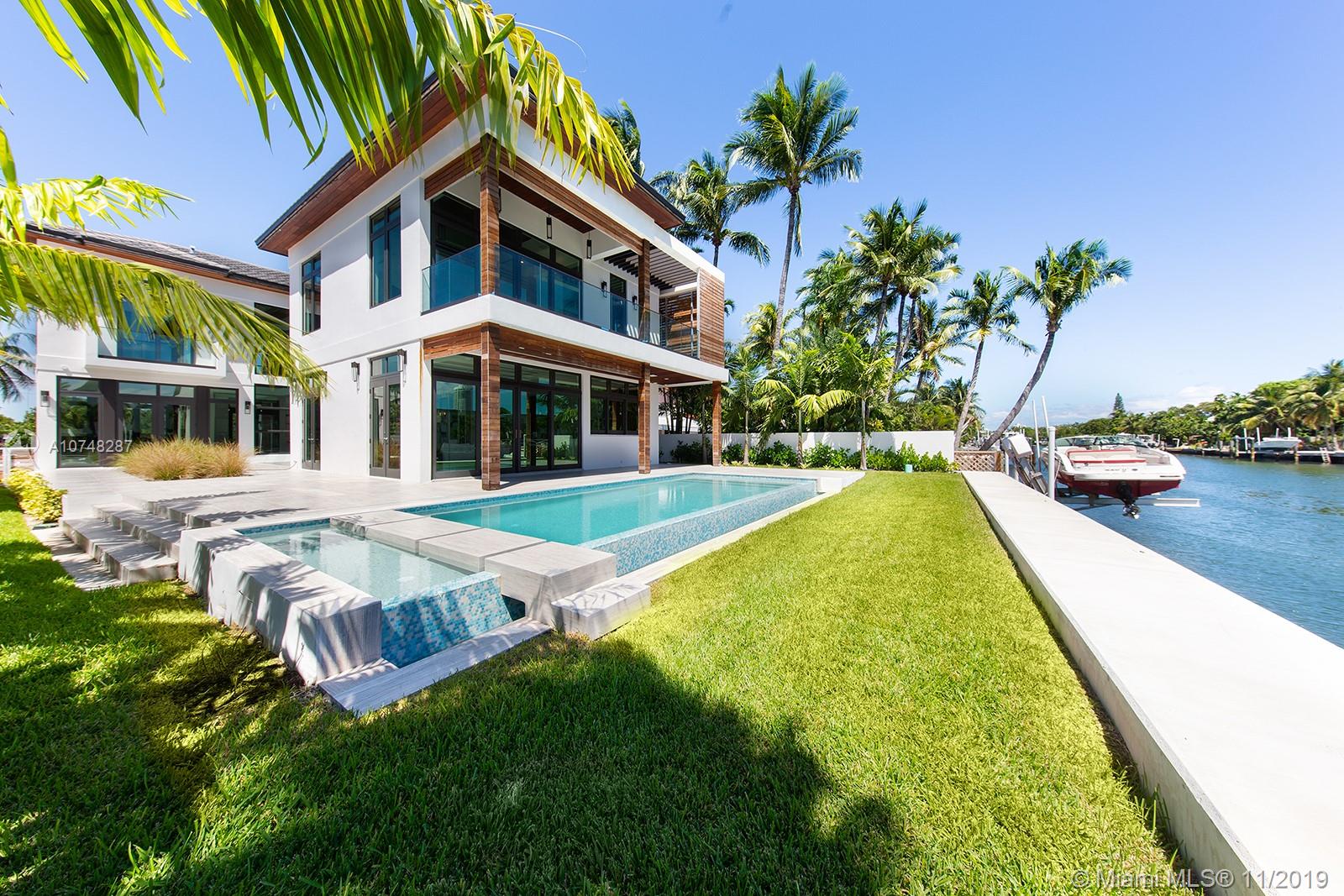Stunning custom built waterfront home wrapped in tropical Brazilian walnut & located in mid-Miami Beach. Finished in Nov 2019, this homes comes with lofted ceilings upon entry, and large south facing windows that naturally lite the spacious living & dining areas. European style custom kitchen with Leicht cabinetry, Subzero & Wolf appliances. Four bedrooms on the second level with a large master suite featuring direct access to a terrace perfect for a sitting area, open plan 5th bedroom on ground floor, stone flooring throughout, marble bathrooms with Lacava cabinets, Gessi showers and Porcelanosa tiles. Two car gallery & smart control system throughout the house.  Lushly landscaped exterior with fire pit, plus soft romantic night lighting surrounding the property. 63 Ft of water frontage.