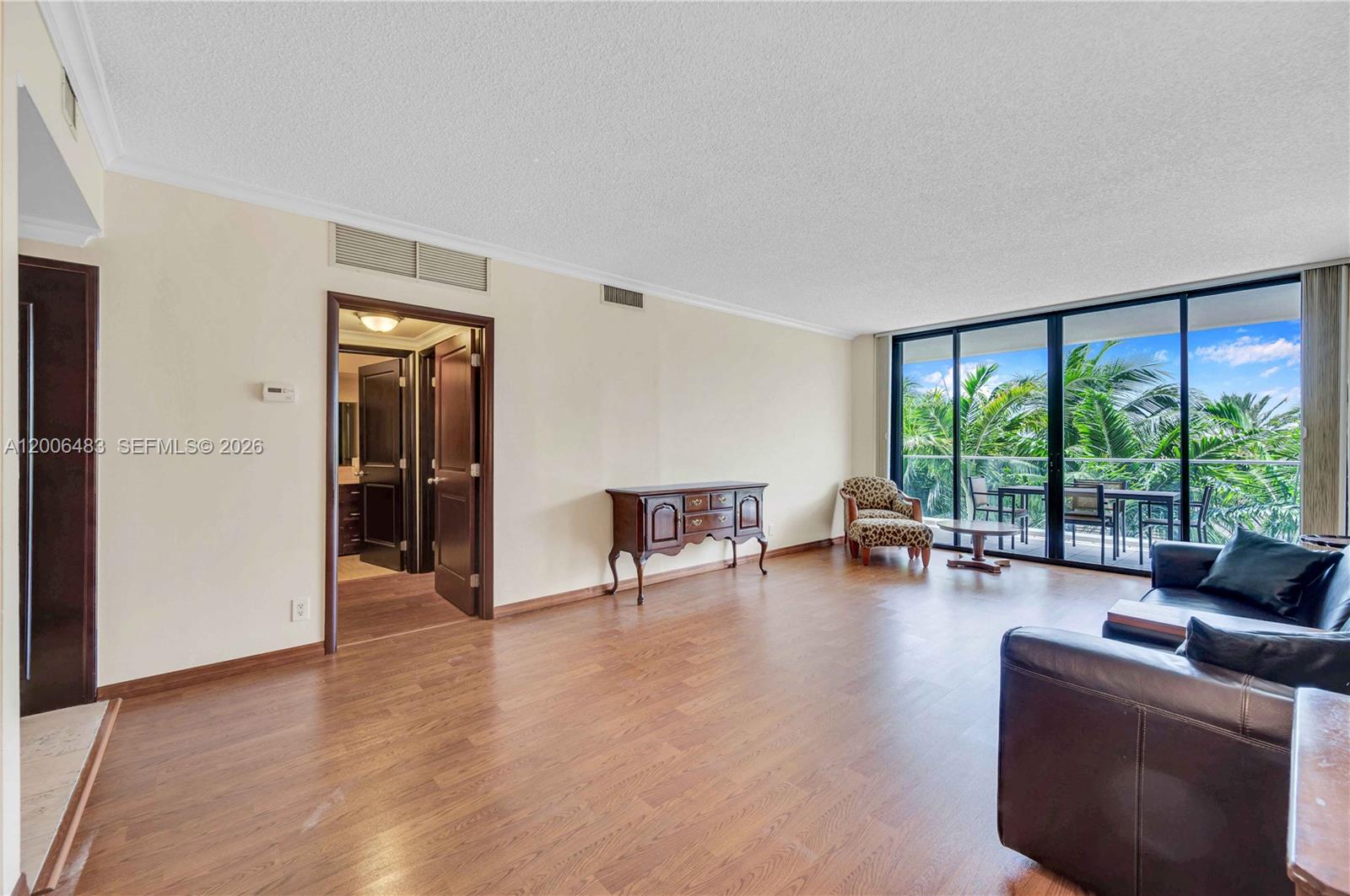 Spacious 1,520 SqFt two-bedroom on Williams Island with warm wood finishes and serene garden views. A large balcony spans the residence with access from every room, creating a seamless indoor-outdoor flow. Split floor plan with custom walk-in closets, wood flooring throughout, and in-unit washer/dryer. Primary suite offers space for a sitting area and a bathroom with a separate tub and shower. The kitchen is well-designed, featuring stainless steel appliances, a pantry, wine cooler, and a comfortable breakfast area. Located in a guard-gated waterfront community offering extensive amenities, including tennis and pickleball courts, pool, spa, fitness center, clubhouse with dining, theater, and more. Conveniently located near houses of worship. Special assessment has been paid in full.
