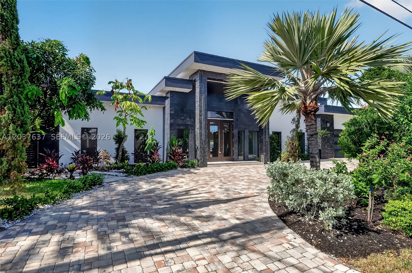 Experience brand-new waterfront living in Fort Lauderdale's desirable Coral Ridge/Galt area. This modern luxury residence offers approx. 3,500 SF of living space with 3 bedrooms plus a den, 3 full bathrooms, and a 2-car garage. The flexible den is ideal as a private office, media room, or 4th bedroom. Designed for bright, open South Florida living, the home features soaring ceilings, impact windows and doors, elegant modern finishes, and expansive glass that brings in natural light and wide water views. The open-concept living and dining areas flow seamlessly to the outdoor pool and waterfront patio, creating an ideal setting for entertaining, relaxing, and enjoying the boating lifestyle. Situated on approx. 100 feet of waterfront with ocean access and no fixed bridges, this property offers a rare opportunity for boaters and buyers seeking new construction on the water. The interior is fresh, modern, and move-in ready, with clean architectural lines and a refined contemporary feel. The spacious layout balances privacy and functionality, while the pool area creates a natural extension of the home for everyday enjoyment. With a 2-car garage, impact protection, and a prime waterfront setting, the property delivers the comfort and convenience today's buyers expect. Located close to beaches, shopping, dining, parks, Las Olas, and all that Fort Lauderdale has to offer, this home combines luxury, location, and waterfront potential in one exceptional package. A must-see home.