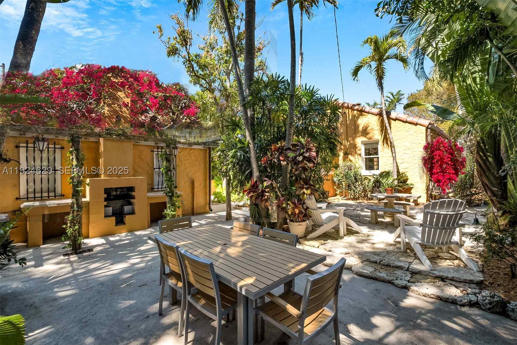 Step into the timeless charm of this beautifully restored 1926 Mediterranean Revival in the heart of Miami Shores. Rich in architectural character yet thoughtfully updated for modern living, this turnkey 2-bedroom, 1-bath residence showcases original hardwood floors, custom millwork, a wood-burning fireplace, and a charming Pecky cypress screened porch. The updated kitchen features stainless steel appliances and blends seamlessly with the home's historic craftsmanship. A rare air-conditioned 400 sq. ft. detached garage offers exceptional flexibility as a home office, gym, studio, or future guest space. Positioned to maximize the usable yard and lush tropical gardens, the property enjoys unique grandfathered site features rarely found today. Just a short stroll to downtown Miami Shores' cafés, restaurants, parks, and neighborhood amenities, this exceptional home offers an ideal blend of history, walkability, convenience, and low-maintenance living. A truly special opportunity to own one of the Village's most distinctive historic residences. Images may be virtually staged and/or digitally enhanced (furniture, colors, fixtures, landscaping) for illustrative purposes only.