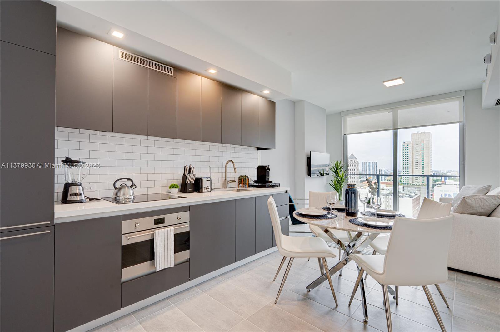 Welcome to 2205 in YotelPad Miami, where luxury meets functionality in the heart of the city. This beautiful apartment boasts an open-concept living area with floor-to-ceiling windows offering stunning views of Downtown Miami. The unit features sleek finishes, high-end appliances, and modern furniture ready to generate income! YotelPad offers residents an array of luxurious amenities, including a state-of-the-art fitness center, a pool with stunning city views, and a 24-hour concierge (& more!). With its prime location in downtown Miami, this unit is perfect for those who crave the energy and excitement of city living. Short-term rental is allowed in this building, perfect for investors and second-home buyers.