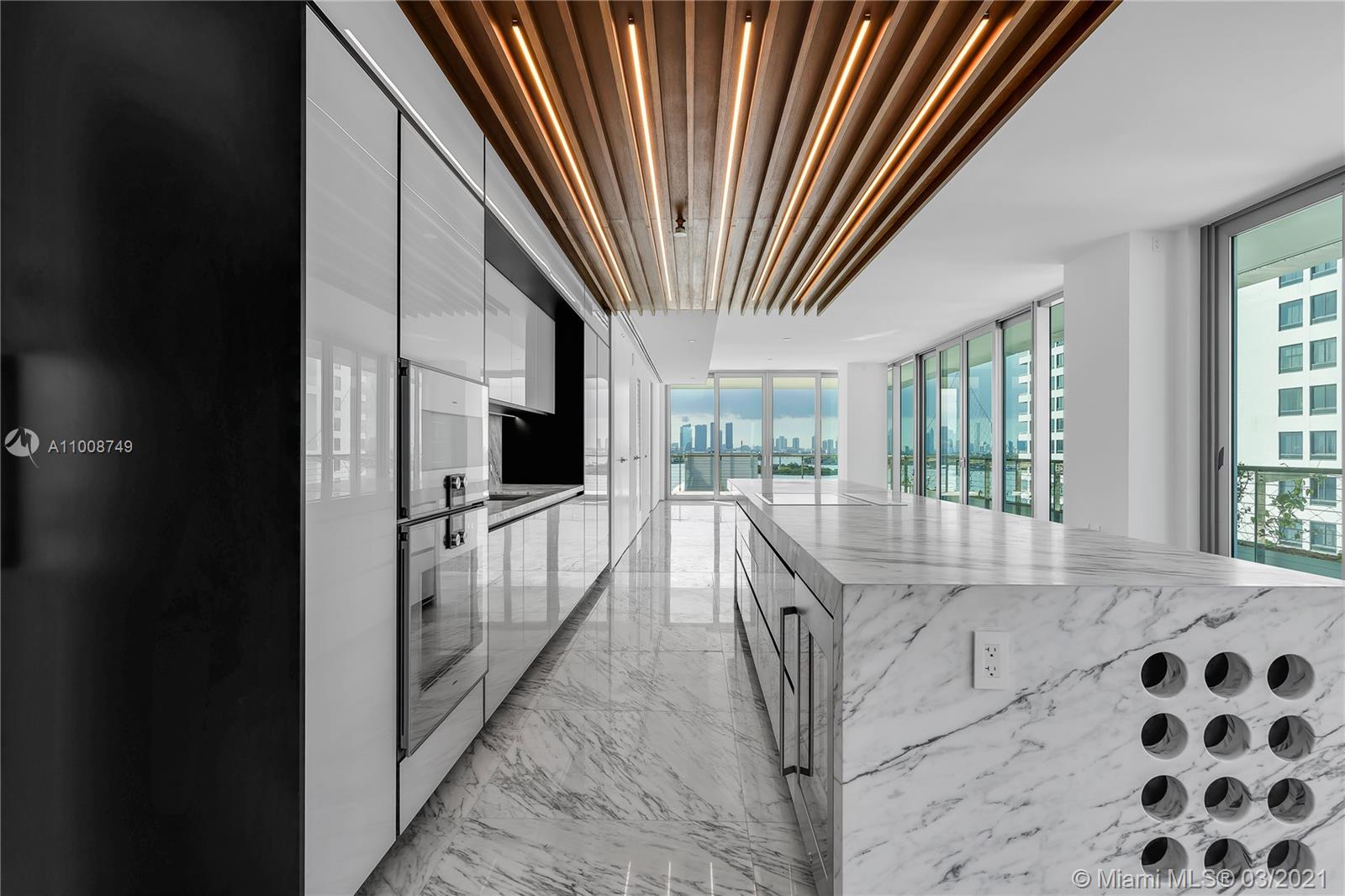 Best line in the building, flow through unit with Direct Sunrise and Sunset views. Dubbed "The Reflection Machine" by architects and Pritzker Prize Winner Ateliers Jean Nouvel, Monad Terrace was designed to emulate the brilliant azure waters of Biscayne Bay. Along with its stunning views, expansive outdoor spaces throughout the building are sheltered by climbing gardens made up of native plants and flowers. This home features dramatic and richly veined Calacatta marble throughout, and has statement making marble island in its kitchen, perfect for entertaining.