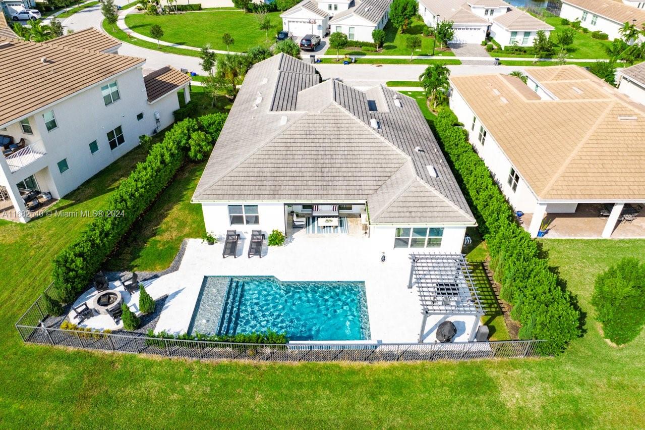 Stunning lakefront home with resort-style amenities!

This lake view retreat offers luxury living on a 1/4 acre. Enjoy a saltwater pool w/ LED lighting, sunshelf, waterfalls &  heated system for year-round fun. Relax by the custom fire pit, in the lanai with a motorized screen, or under the pergola - this home offers outdoor living at it's best. The lush landscaping has a smart sprinkler system & Clusia hedges for privacy. 

The 3-car garage smart garage includes a 240V plug for EVs & lots of space for cars & a golf cart. Inside, the generous layout, modern design and updated appliances offer a turnkey estate home perfect for your family. Enclosed den may be used as 4th bedroom.

Community:
Westlake Adventure Park has basketball, pools, slides, a splash pad, playgrounds, and more.