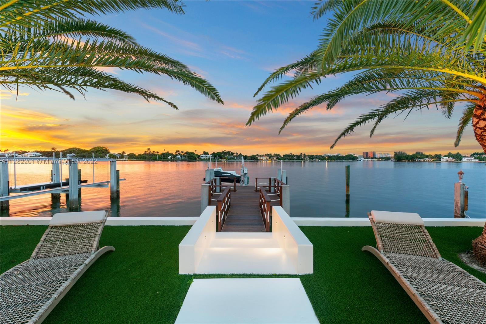 Incredibly scenic views across the wide water and onto the magnificent estate properties of Billionaire's Bunker on Indian Creek! Watch the yachts sail by while enjoying beautiful sunrises and sunsets. Spectacular mid-century modern with an elegant and charming interior that's been finished to the nines and adorned with fine touches from Britto Charette, porcelain-wood herringbone floors, Lutron and Sonos technologies, and so much more. A boater's paradise  equipped with a lift for boats/jet skis, heated saltwater pool and BBQ area, the home is great for families and prefect for entertaining. One of Miami’s very few gated island communities with all waterfront properties. Ideal location nearby schools, a multitude of dining options and shops, and just minutes from the white sand beaches.
