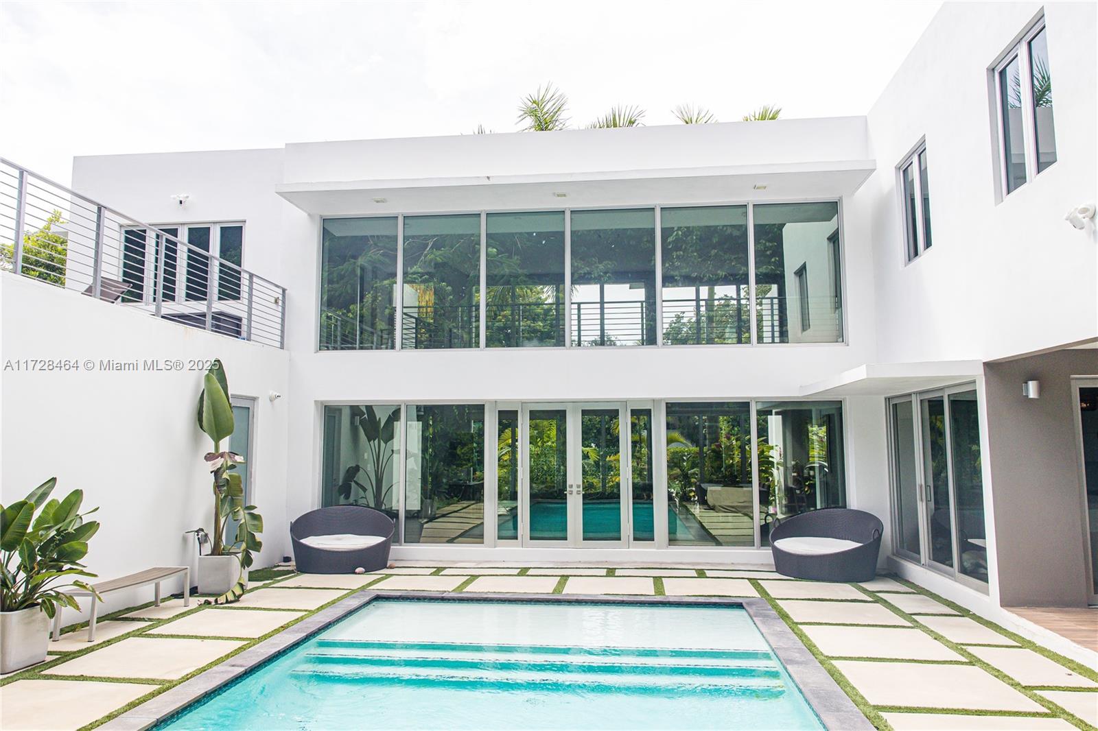 UNLEASH THE POTENTIAL OF MODERN LUXURY IN THE HEART OF SOUTH MIAMI. Experience a rare opportunity to own a contemporary architectural gem in one of Miami’s most sought-after enclaves. This 2017-built residence, spanning over 3,500 square feet of interior living space, is a masterclass in modern design awaiting your final touches to return it to its full glory. Boasting a soaring, light-filled open floor plan, the home seamlessly integrates indoor and outdoor living through floor-to-ceiling glass, framing views of your private tropical oasis. This expansive layout features 5 generous bedrooms, 3.5 designer-ready baths, and a versatile den perfect for a home office or media room. The chef-inspired kitchen serves as the heart of the home, flowing effortlessly into the great room and out to the pool deck. Outside, discover a walled and gated sanctuary complete with a sparkling private pool, a dedicated sundeck, and lush landscaping that offers total serenity. With a 2-car garage and a large gated motor court, there is ample space for the modern family or car enthusiast.