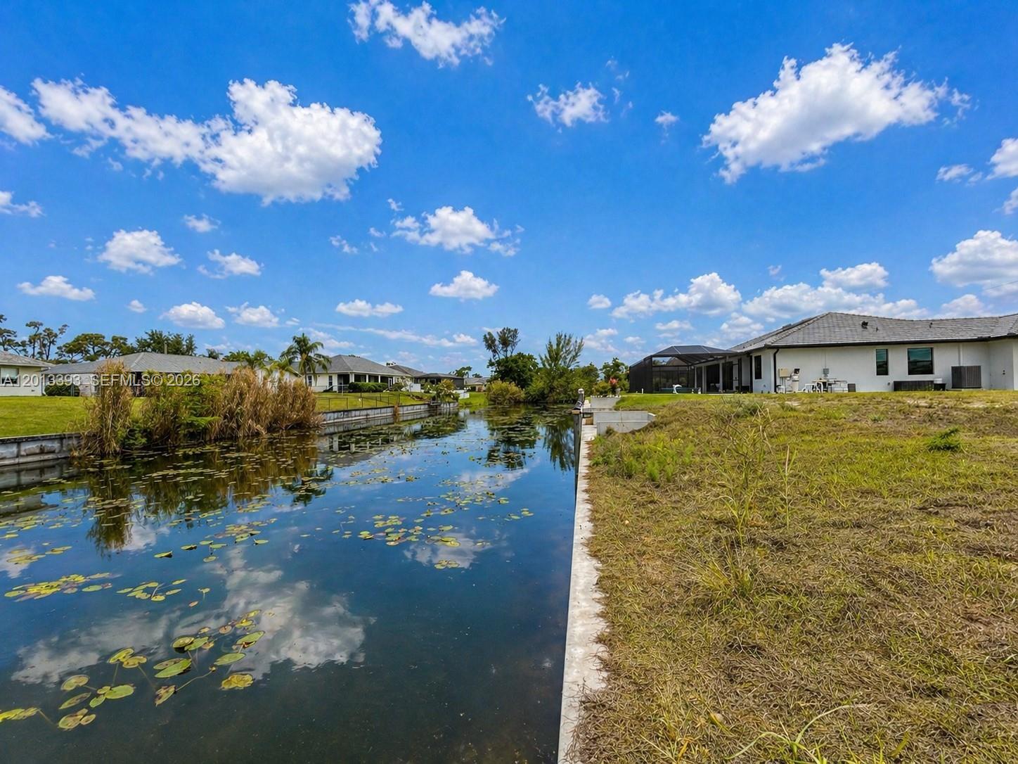 Exceptional canal-front residential lot in desirable Cape Coral, offering a great opportunity to build your future Florida home. This vacant lot features freshwater canal frontage, desirable southern rear exposure, concrete seawall, and concrete boat dock added in 2024. The property offers approximately 0.23 acres and is located on a paved public road with municipal water, sewer, and irrigation available per owner information. No HOA. Ideal setting for outdoor living, boating on the freshwater canal system, and enjoying the Cape Coral lifestyle. Conveniently located near shopping, dining, parks, schools, golf, and entertainment, including Sun Splash Family Waterpark and nearby main roads. Buyer to verify zoning, utilities, building requirements, dock/boat restrictions, and all information with the City of Cape Coral and appropriate authorities.