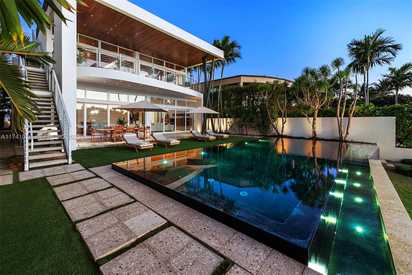 Stunning contemporary home on tropical Venetian Islands with 60-ft waterfrontage and dreamy Miami skyline and sunset views! Manicured to perfection, this luxe home features double-height foyer, sunlit living areas, gourmet kitchen, high ceilings, Crestron Control, terrazzo and marble floors, and elegant wood-paneled ceilings. Upstairs, an exceptional family room and indulgent master suite with generous walk-in closets and luxe bath. Amenities include dock, VIP guest suite, backyard oasis with saltwater infinity pool, patio for outdoor dining, sprawling rooftop with wet-bar, hot tub, and lounge beds, deep terrace with outdoor shower and access to backyard. Enjoy Miami’s waterfront lifestyle and all the best that South Beach and Miami can offer.Ideal for outdoor enthusiasts and entertainers!