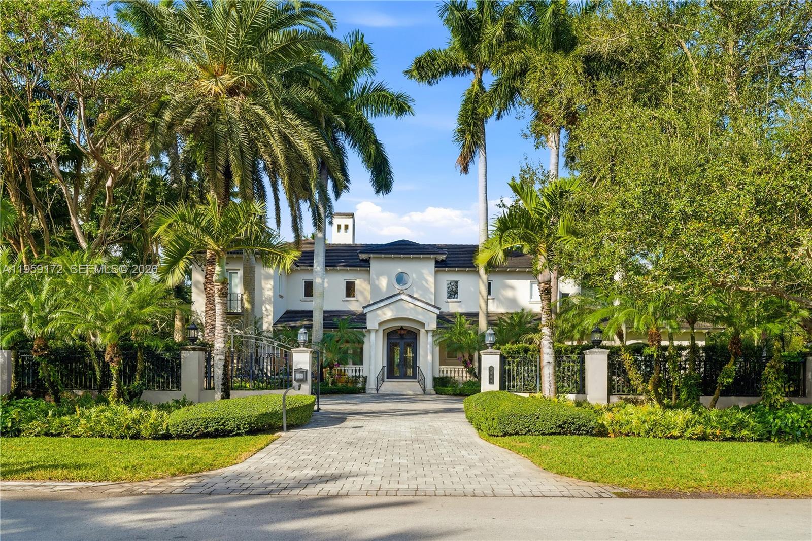 Fantastic gated corner acre-estate in Ponce-Davis with everything you could want for the active family lifestyle! Renovated in 2019, this estate includes a grandfathered lighted-tennis/pickleball court, large pool and spa area, huge family room with built-in bar, billiards room/playroom, media room, library/office, large wine vault, and detached guest house with built-in barbecue and fridge. Also staff quarters, an elevator, and a full-house generator.  Located in one of Miami's most coveted neighborhoods. Just minutes from top schools and the best that Coral Gables has to offer!