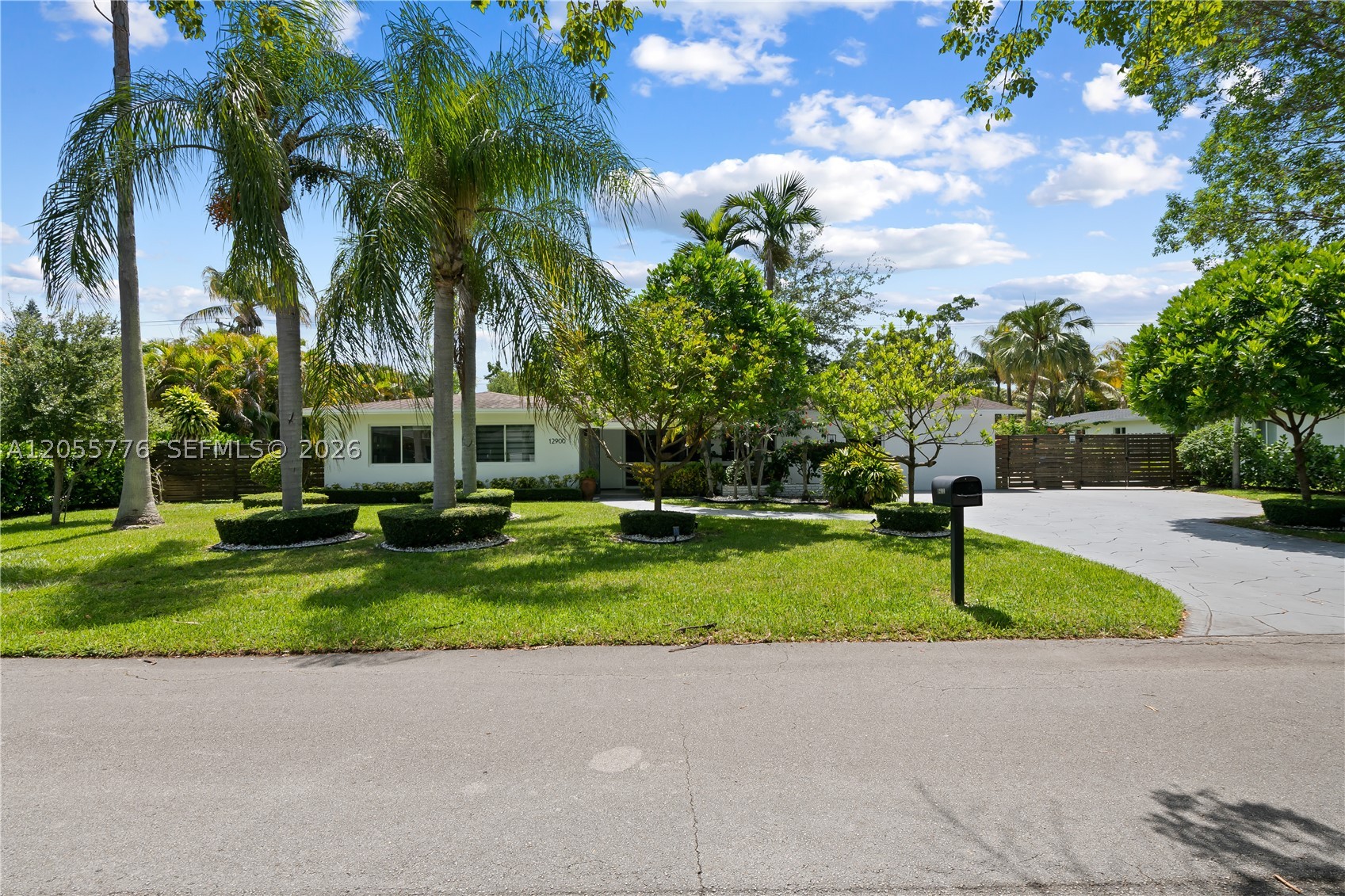 Welcome to this exceptional Pinecrest residence, perfectly situated on a quiet, tree-lined street in one of the area’s most desirable neighborhoods. This beautifully maintained 4-bedroom, 3-bathroom home features a bright, open-concept floor plan designed for comfortable everyday living and effortless entertaining.
The spacious chef’s kitchen is appointed with stainless steel appliances, a built-in wall oven, and flows seamlessly into the living and dining areas, creating a warm and inviting space filled with natural light. Impact windows throughout provide added security, energy efficiency, and peace of mind. Step outside to your own private tropical retreat, where a lushly landscaped backyard with mature fruit trees offers the perfect setting for outdoor dining, entertaining.