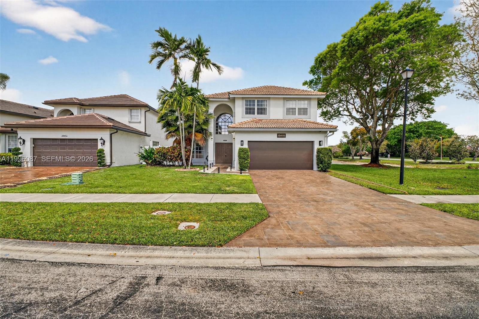 Beautifully updated 2-story home in Lakes at Boca Raton featuring 3 bedrooms + office/den, 2.5 baths, and a 2-car garage. Light-filled interior with soaring ceilings, large arched windows, and open living and dining areas. The renovated kitchen features quartz countertops, a center island, modern cabinetry, and stainless steel appliances, opening to a family room. The primary suite offers dual vanities, a soaking tub, a separate shower, and a custom walk-in closet. Additional highlights include updated flooring, a contemporary staircase with a glass railing, and stylish finishes throughout. The private backyard has a covered patio and space for entertaining, overlooking tranquil water views. Interior laundry and ample storage are included. Community amenities include a pool, tennis courts, a playground, and walking paths. Conveniently located near schools, shopping, dining, and major roads.