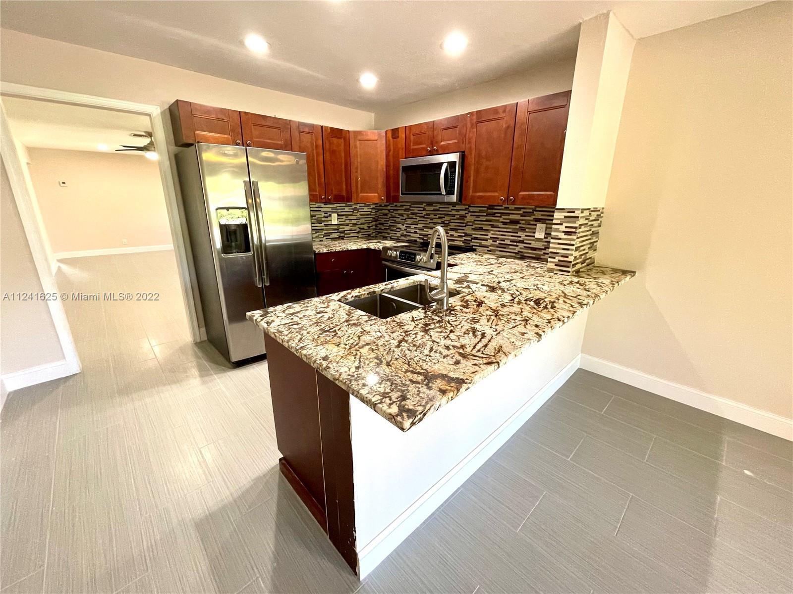 Completely upgraded & freshly painted 4/2 half duplex unit featuring a spacious layout with tile floors throughout. New Kitchen with granite counter tops, SS appliances and wood cabinets. Large master bedroom with 2 closets & a private upgraded bathroom with granite & dual sinks. Spacious guest bedrooms & an upgraded guest bathroom. Indoor laundry / utility room. Beautiful large backyard with a paved & covered private patio overlooking the shared pool and the canal. Large driveway that can fit 4 cars. Located in a very quiet neighborhood in the amazing city Coral Springs! the property is vacant, ready and easy to show. DON'T WAIT!! SCHEDULE YOUR SHOWING TODAY!