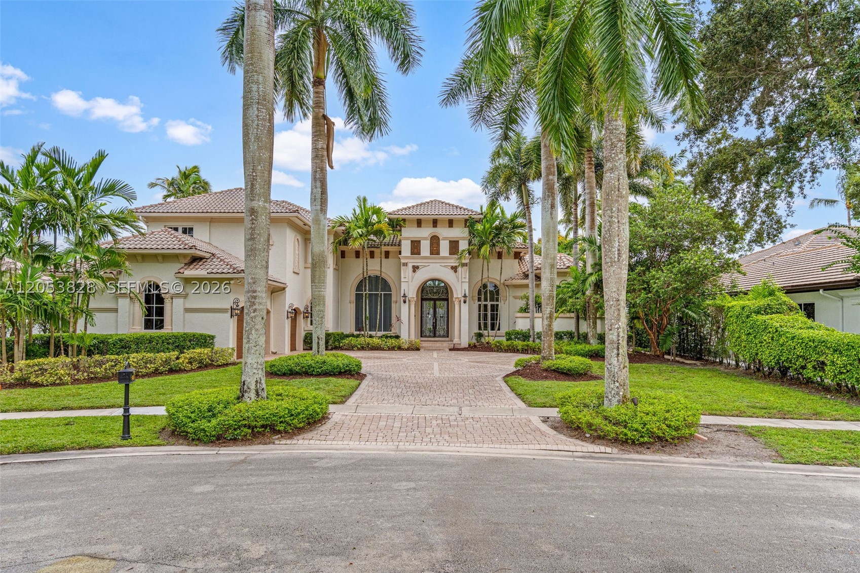 Welcome to one of the premier luxury homes in the prestigious gated community of Hawks Landing in Plantation. Renowned for its elegant custom estates, tree-lined streets, and resort-style amenities, Hawks Landing is one of Broward County's most sought-after neighborhoods. Residents enjoy 24-hour guard-gated security, tennis courts, a fitness center, clubhouse, playgrounds, and convenient access to shopping, dining, major highways, and Fort Lauderdale-Hollywood International Airport. This impressive estate offers approximately 6,800 square feet of living space with six bedrooms, six full bathrooms, and two half bathrooms. Designed for both everyday living and entertaining, the home features soaring 23-foot ceilings in the main living area, creating an open, light-filled atmosphere. The thoughtfully designed floor plan includes a first-floor primary suite, spacious secondary bedrooms, a custom movie theater, and a wet bar perfect for entertaining. The backyard overlooks peaceful water views, providing a tranquil setting to enjoy South Florida's outdoor lifestyle. A rare opportunity to update and personalize a spacious waterfront estate in one of Plantation's most prestigious gated communities.