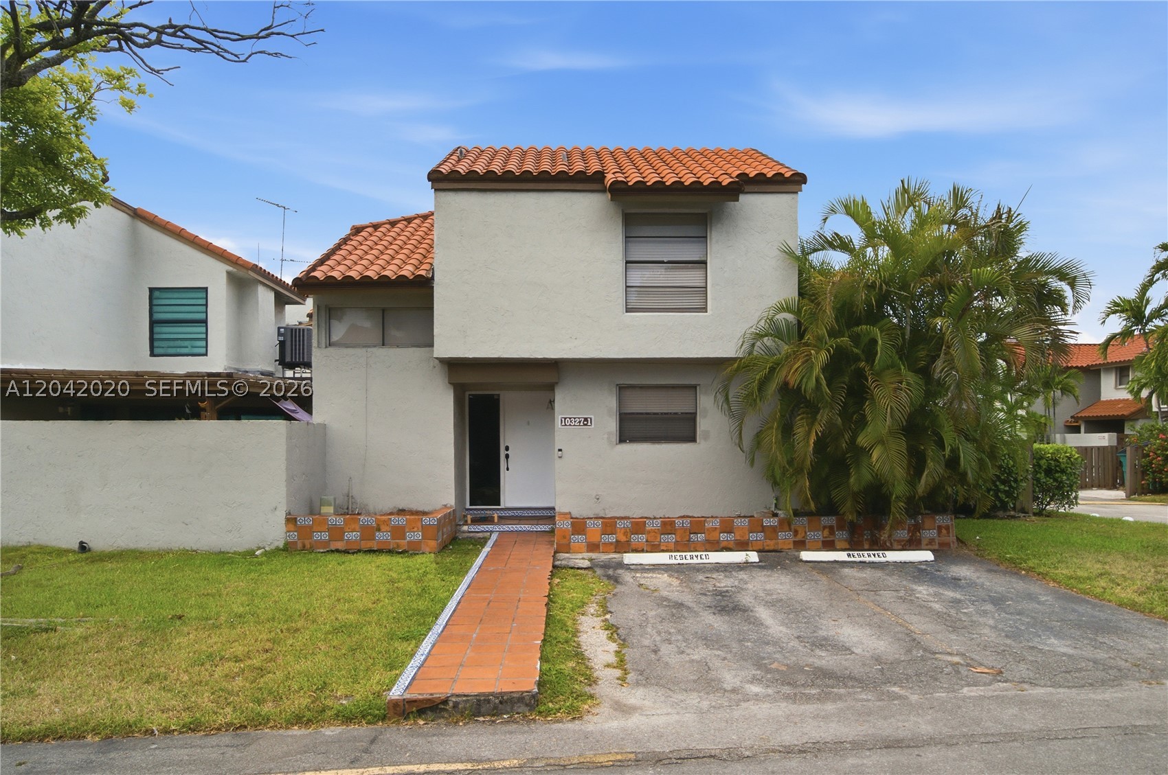 Welcome to this spacious and centrally located 3-bedroom, 2-bathroom townhome/villa in the highly desirable Caribbean Springs Village community. This two-story residence features tile flooring throughout the main living areas and attractive wood flooring on the staircase.  The thoughtfully designed layout includes one bedroom and a full bathroom on the first floor, making it ideal for guests, extended family, or a home office. Enjoy a large living and dining area perfect for everyday living and entertaining.  The updated kitchen is equipped with stainless-steel appliances, and a separate full laundry room adds convenience and extra storage space.  The community features two assigned parking spaces directly in front of the unit, ample guest parking, community swimming pool, tennis courts, and a children's playground.  Conveniently located in the heart of the Fontainebleau area, this home offers easy access to major highways, shopping, dining, schools, and entertainment.