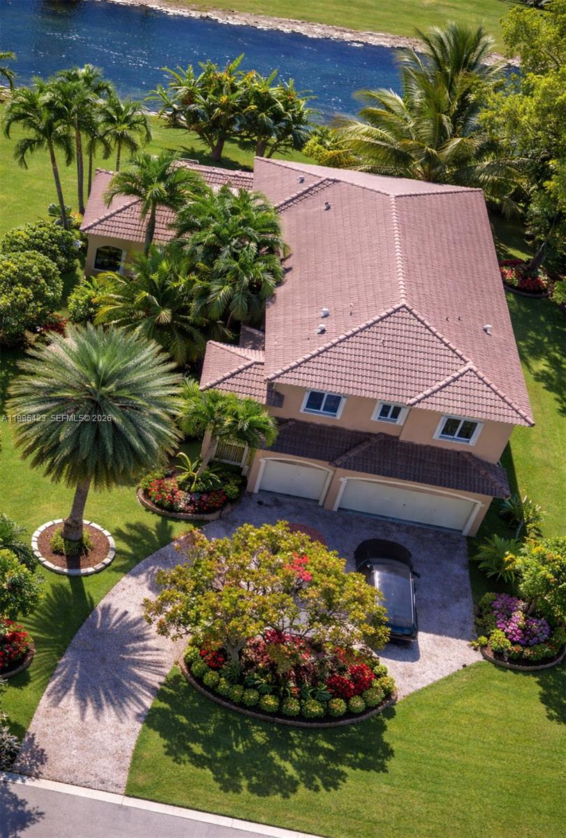 Beautiful 5-bedroom 4 full bath 2 half bath + a private in law suite with separate entrance, perfect for guess, office, gym, or extra income on one of the larger lots in the subdivision. Relax in your pool with spa and waterfall treatment, surrounded by many fruit trees and palms, and enjoy the view of the golf course and a calm canal.
Huge master bedroom suite with large master closet, big kitchen with granite counter top. Accordion shutters and 35k standby generator. State of the art camera system and upgrade alarm by protection 1. Intercom system throughout house. Garage cabinets. Two new Amana 4 ton A/C recently installed. 3 car garages + drive way for 4 more cars. Internet and multi channel cable are provided by HOA