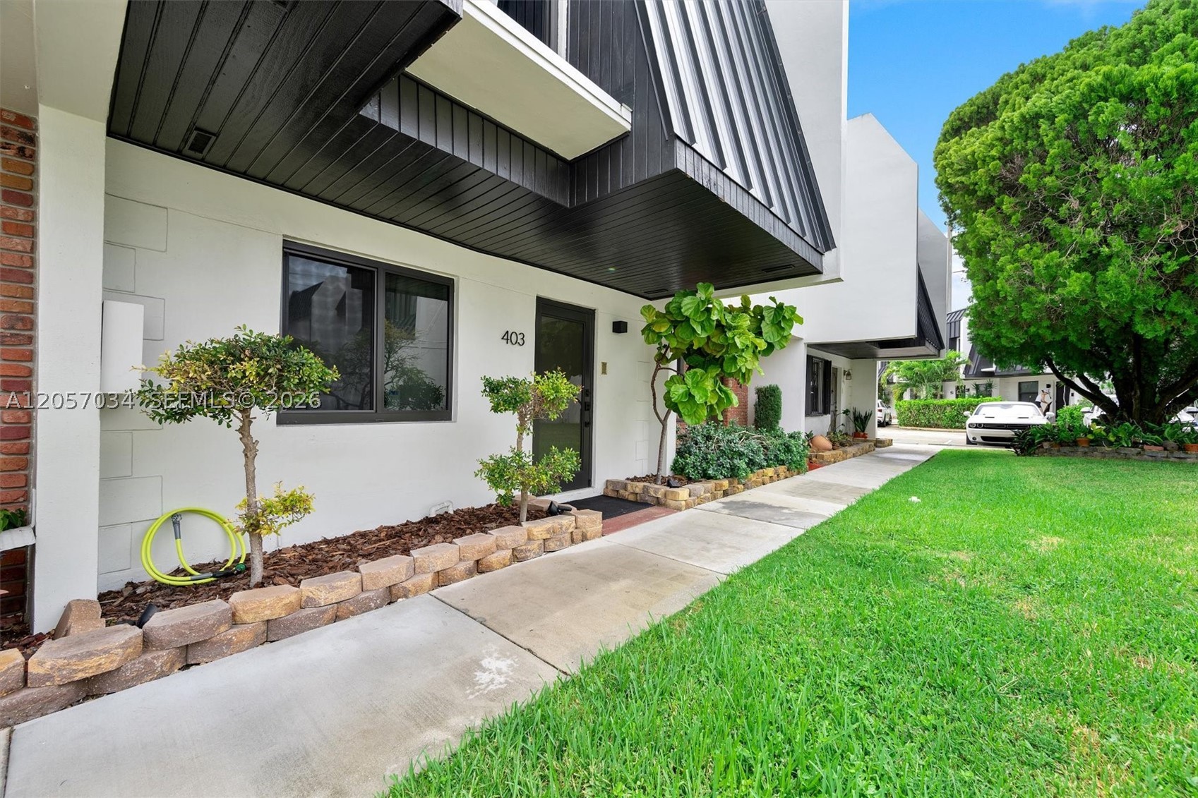 Beautifully updated 2-bedroom, 2.5-bath townhome in the desirable Miller Sixty-Seven community. This bright two-story residence features an open living and dining area with dark wood-look flooring, upgraded baseboards on the first floor, modern white finishes, and quality tinted impact windows throughout that fill the space with natural light, plus a frosted impact front door. The stylish kitchen offers white cabinetry, quartz countertops, stainless steel appliances, and a large island with seating and storage below, while a convenient half bath and in-unit washer/dryer complete the main level. Upstairs you’ll find two comfortable bedrooms, each with its own full bathroom. Black impact French doors lead to a private enclosed patio perfect for relaxing or entertaining. Enjoy a well-maintained community with pool access, assigned parking, and a prime location minutes from the University of Miami, Coral Gables, South Miami shops, restaurants, and major roadways. Move-in ready and ideal for professionals or small households seeking low-maintenance living in a great South Florida location. HOA has healthy reserves.