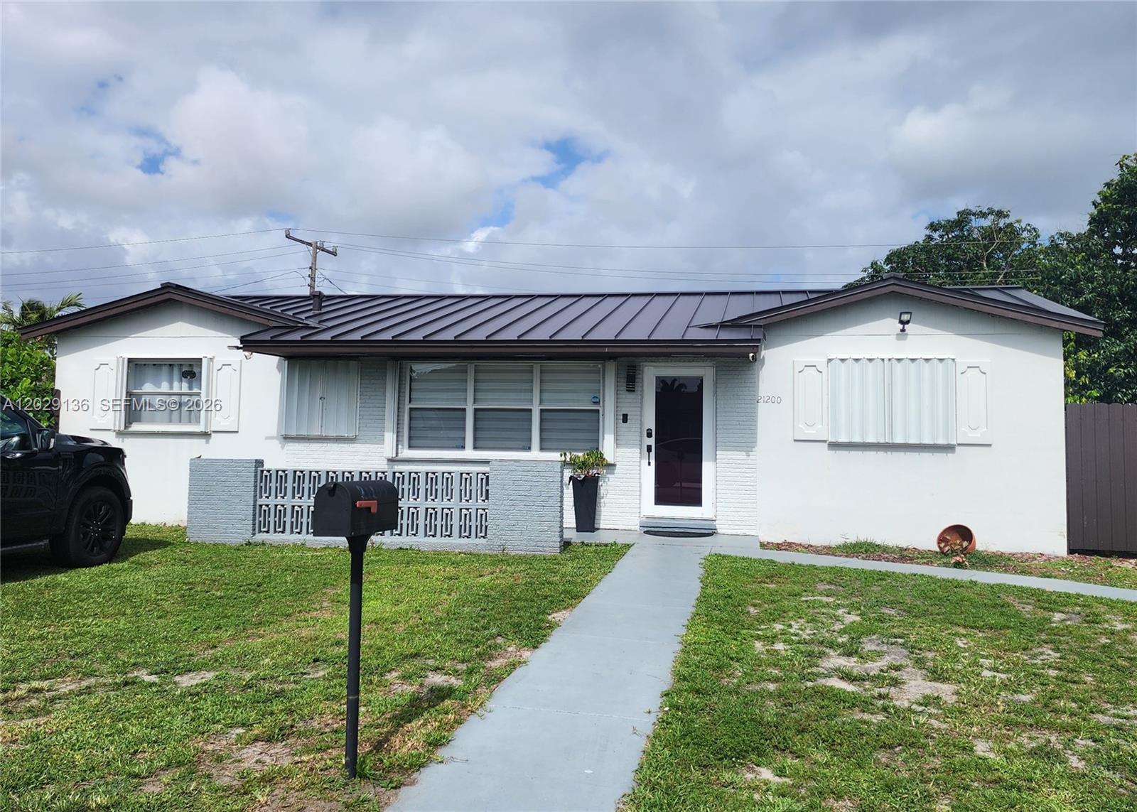 Blocks from Hard Rock Stadium! No HOA. Income-producing opportunity currently generating $6,700/month in rental income, with potential to reach $7,000+ per month. This single-family residence is currently configured as a 5-bedrooms, 5-bathrooms with four separate living areas. The main house is a 2 bed/ 2 baths, living/dining area, and a full kitchen, rented at $2,700/mo., the side unit includes Kitchen/dining/living space with 1 bedroom and a full bathroom, rented at $1,600/mo. and two apartments at rear side with Kitchen/dining/living space with 1 bedroom and a full bathroom each that generates $1,200/mo. each. The property boasts a brand-new 2024 roof, energy-efficient tankless water heaters, a main-house laundry room, central A/C at front, and independent mini-splits in the remaining units. The exterior offers a large parking area and a fully fenced backyard with private dual-side entrances. Do not miss this rare, high-yield cash generator situated in a prime, high-demand location near major highways, premium shopping, and world-class entertainment!