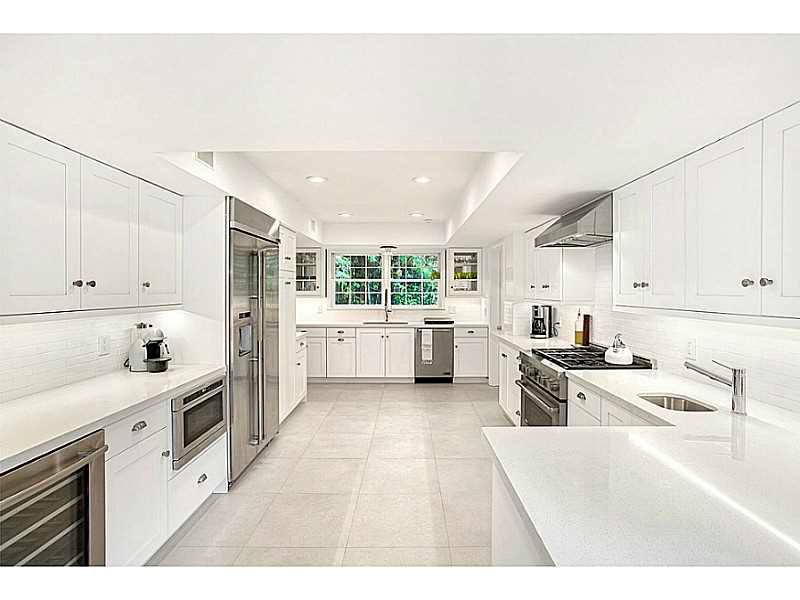 Live on prestigious La Gorce Island in this stunning, completely renovated colonial style home. Sitting on a 17,000SF Lot this beautiful 5,453SF 2 story home boasts 7BR/6+1BA, a gourmet kitchen w/ top of line appliances & finishes, fireplace, pool, restor ed wood floors, french doors, an expansive master suite w/ 4 walk-in closets & large ensuite bedrooms throughout. Enjoy contemporary yet classic finishes & ample natural light beaming through the family & living rooms overlooking the pool & lush garden.