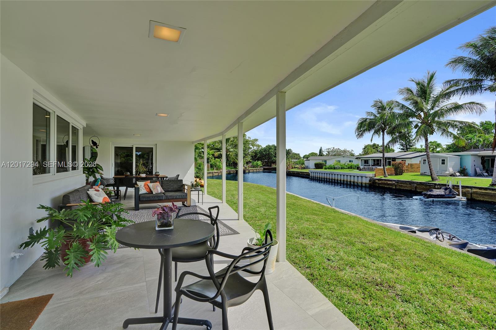 Situated on an impressive 118’ waterfront lot, this beautifully remodeled custom residence offers 2 bedrooms, 2 bathrooms, and a one-car garage in the highly sought-after Royal Palm waterfront community. Renovated between 2022 and 2023, the home features updated plumbing, electrical, flooring, bathrooms, kitchen, appliances, laundry room, roof, impact-resistant windows, doors, and garage door. A beautiful mature oak tree enhances the curb appeal, while the expansive covered patio overlooks the wide canal, creating the perfect setting for relaxing or entertaining, with plenty of room to add a pool. The property is ideally located just 4 miles from the beach, approximately 15 minutes from downtown Fort Lauderdale, and close to shopping, dining, and the airport. Whether as your primary residence or second home, this property offers the perfect blend of comfort, style, and South Florida waterfront living.