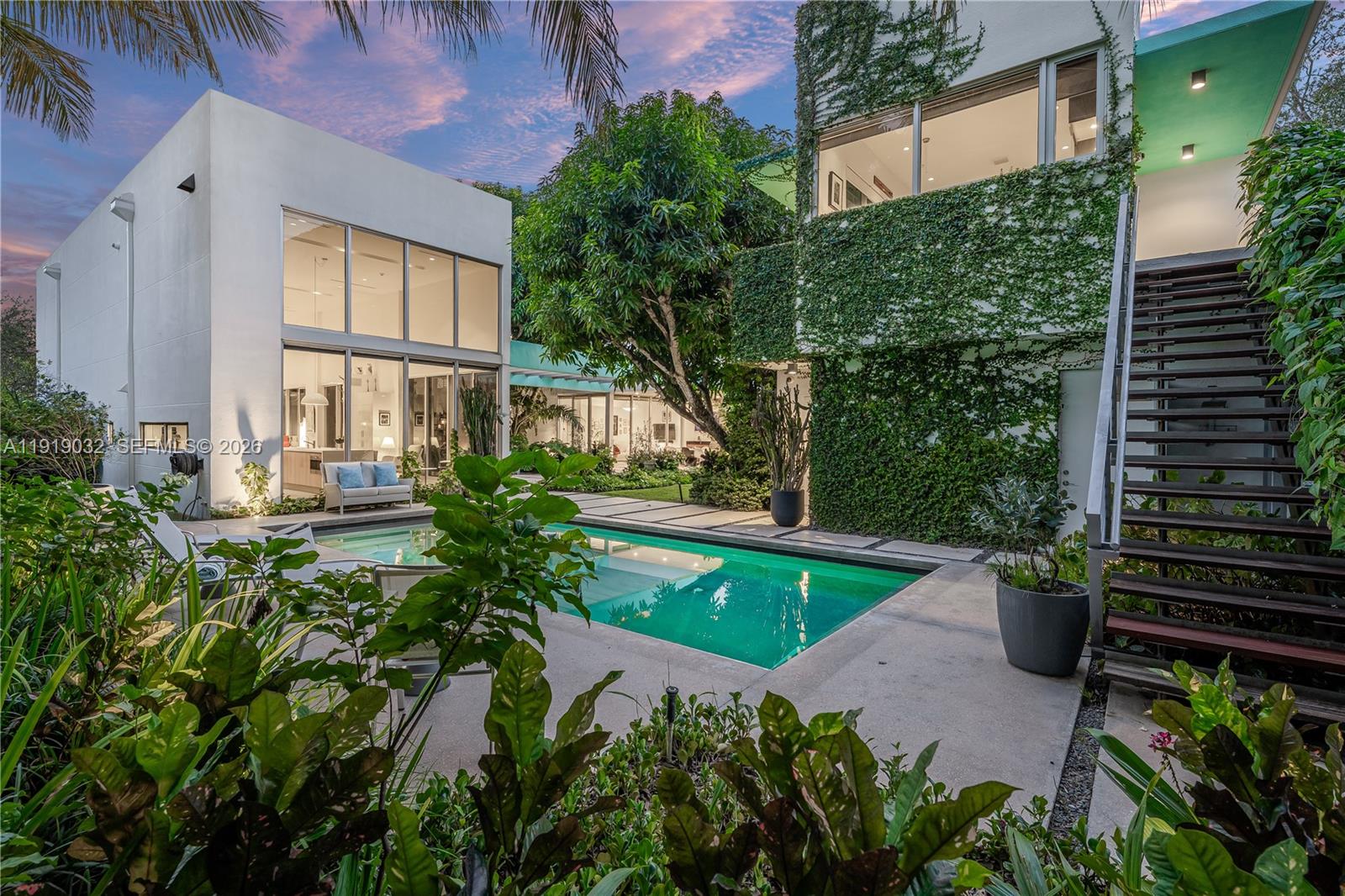 A masterpiece of contemporary luxury living designed by renowned Miami architect Roney Mateu, this exceptional self-contained estate - comprised of two separate structures - offers privacy, security, and architectural distinction on a 15,430 SF corner lot. The main residence features 5 bedrooms, 4 full and 1 half bathrooms, highlighted by soaring 20-ft ceilings, expansive floor-to-ceiling glass walls, and abundant natural light that create a gallery-style living environment. Lush tropical landscaping surrounds the property, delivering a rare sense of seclusion, privacy and tranquility.

The resort-style outdoor living area includes a sparkling swimming pool, outdoor kitchen, and private outdoor shower, ideal for Miami indoor-outdoor living and year-round entertaining. At the center of the home is a custom MiaCucina kitchen equipped with Wolf and Sub-Zero appliances, perfectly suited for modern family living and hosting.

A truly rare offering, this is the only home in the area with a separate detached guest house, featuring its own +/- 500 SF apartment with full kitchen, full bathroom, and two-car garage below—ideal for guests, extended family, a home office, artist’s studio, or private retreat, all while maintaining complete independence and security.

Ideally located in one of Miami’s most desirable family neighborhoods, the property is within walking distance to Gulliver Schools and minutes from other top private academies, parks, shopping, and lifestyle amenities.