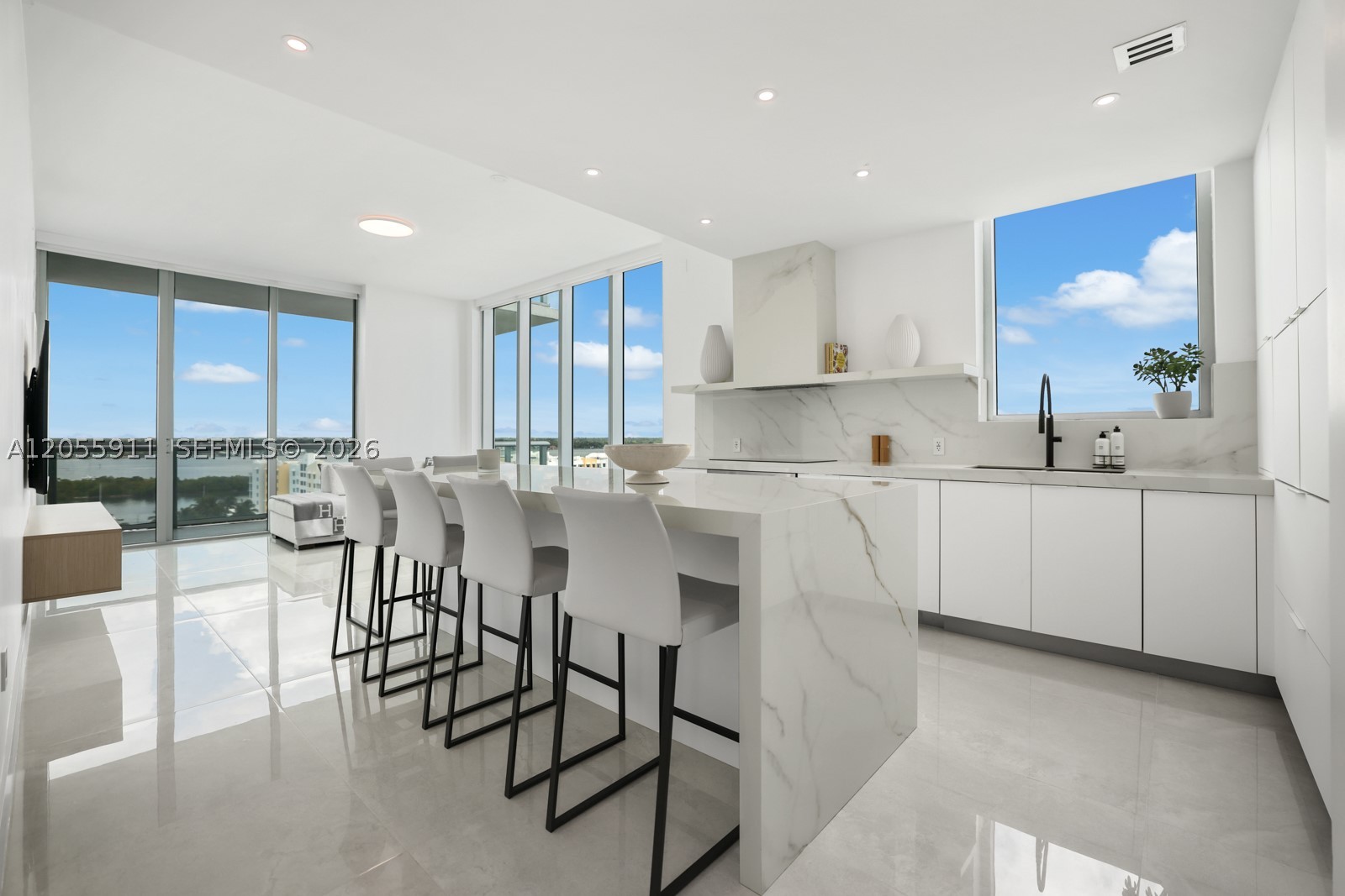 Live well in the most sought-after line in the building. This fully renovated 3BR/3BA residence commands expansive 270-degree views of Biscayne Bay and has been reimagined top to bottom with no expense spared. The chef's kitchen features Italian Calacatta Gold porcelain countertops, custom Dax cabinetry, and Thermador appliances. Italian ceramic tile flows throughout, complemented by custom floor-to-ceiling closets for exceptional storage. Spa-like baths showcase ultra-clear glass enclosures and Calacatta gold porcelain vanities. Enjoy three water-view balconies, impact windows, and impact sliding doors throughout — this one-of-a-kind, turnkey unit was recreated for the most discerning owner. Building amenities include a private marina, 24-hour security, gym, pool, jacuzzi, tennis court, half basketball court, and gated garage.