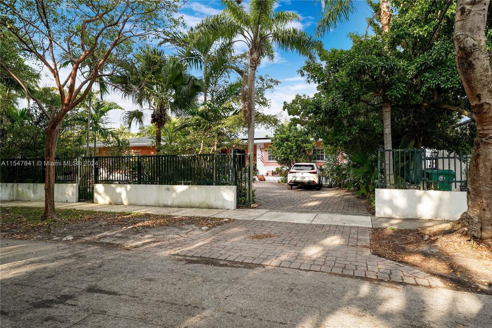 Gated Home in desirable Bay Heights. Double door entry opens to foyer and spacious open floor plan with living, dining and a fabulous family room overlooking beautiful pool and patio. Bonus room: office/den. Master + two bedrooms have gleaming hardwood floors, 4th bedroom has potential to be great in law quarters (with its own entrance). Bike to bayfront parks & marinas. Minutes from downtown, MIA, Key Biscayne & the Beaches.