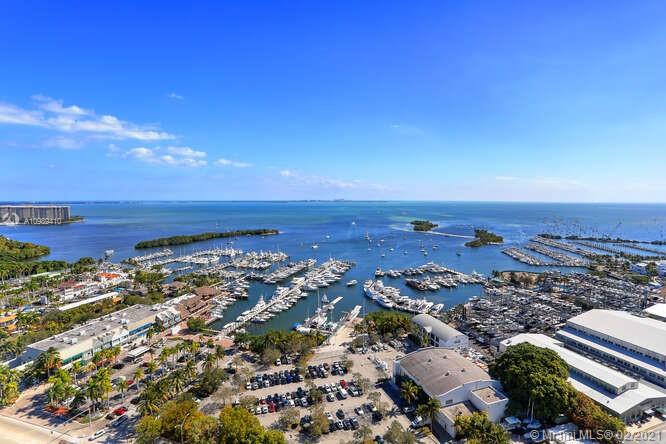 Enjoy breathtaking views from this luxurious home in prestigious Grovenor House. Your private elevator opens to a 29th floor oasis with 4 bedrooms, 5.5 baths, 4370 sf living area and 1500 sf of wraparound balconies. Unobstructed bay/ocean views from the spacious living room and fabulous sunset views from the den. Wake up in the dreamy master bedroom with oversized balcony and his and hers bathrooms and walk-in closets. Cooks will love the Italian kitchen cabinetry and Miele appliances with double refrigerators, freezers and ovens. World class amenities include huge pool, jacuzzi, BBQ, tennis, basketball, gym, spa, dog park, children's playground and more. Walk to restaurants, shopping and nightlife in Coconut Grove. Two parking spaces, plus 2 additional spaces available for $50,000 each.