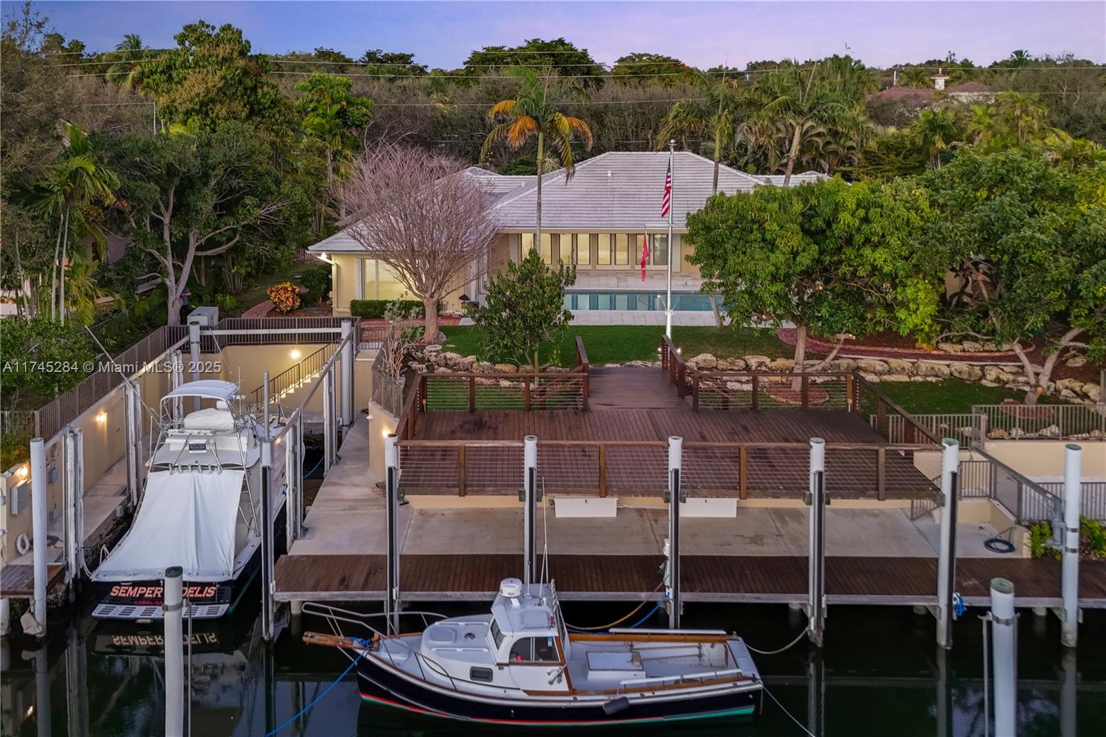 Welcome to your Yachtsman's Paradise where your Luxury Yacht, Weekender & Cruiser Yacht are all parked behind your home on your very own mini marina on the Coral Gables waterway. The 2-story deck & dock were robustly constructed with stainless steel hardware, vinyl clad pilings & tide slides to ensure your boat is hurricane-ready. 200 amps of electricity have been thoughtfully included to provide the means to maintain your prized watercrafts. The inlet is sheltered for privacy & protection from storms & the higher elevation assists in storm surge. This home is your paradise in Coral Gables, where luxury living meets the enchanting allure of waterfront adventure. *Listing pictures have been virtually staged*