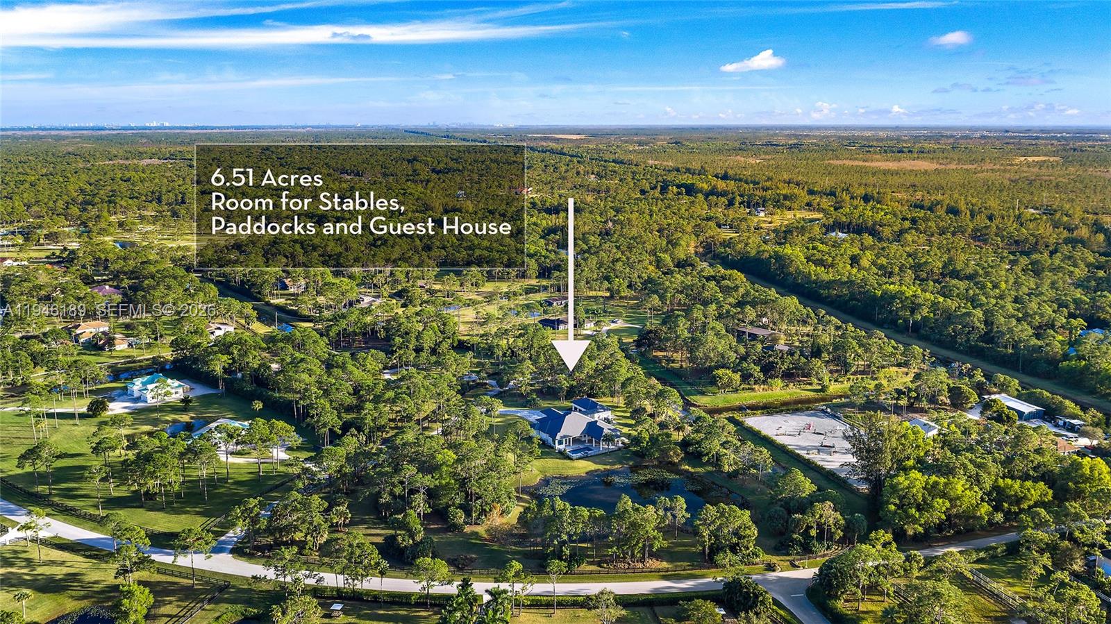 Positioned on 6.51 acres within a private estate community known for expansive homesites and custom residences, this newly constructed home offers a rare balance of privacy, scale, and flexibility. The acreage allows for a variety of uses—whether as a private retreat complemented by a four-bay garage with lift-height ceilings, or with the option to expand into an equestrian setup or add separate guest quarters. The living space is open and modern, with high ceilings and warm, luxury farmhouse finishes. The home is well-equipped with a full-house reverse osmosis (RO) water system, propane tank, and generator hookup. Indoor living extends to a covered patio with speakers and a summer kitchen, alongside a heated saltwater pool and spa. All bedrooms are ensuite, with a dedicated office/den and a spacious media or recreation room. Located near the community’s 30-acre equestrian park, miles of bridle trails, and nearby stables—yet just minutes to shopping, dining, golf, and the beach—the setting offers a balance of privacy and convenience.