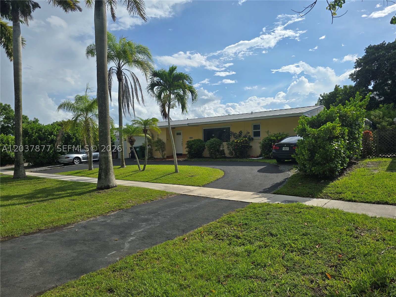 This bright and spacious 4 bedroom 2 bath home is located in a prime area of Cutler Bay. It has plenty of possibilities. The garage was converted to an efficiency with a side entrance. The house features a split bedroom floor plan. The primary bedroom has a large walk- in closet and a bathroom with a large Roman tub. The living areas have upgraded vinyl flooring that looks like wood and carpeting in the bedrooms. The galley kitchen has  wood kitchen cabinets, quartz counter tops, and stainless steel appliances. The house has a newer metal roof, and central A/C system, providing peace of mind. The large backyard has fruit trees, a patio & room for a pool. There is a Ygreen lien on the property that will be paid off at closing. This As-Is home is waiting for your personal touches. Bring you offers!