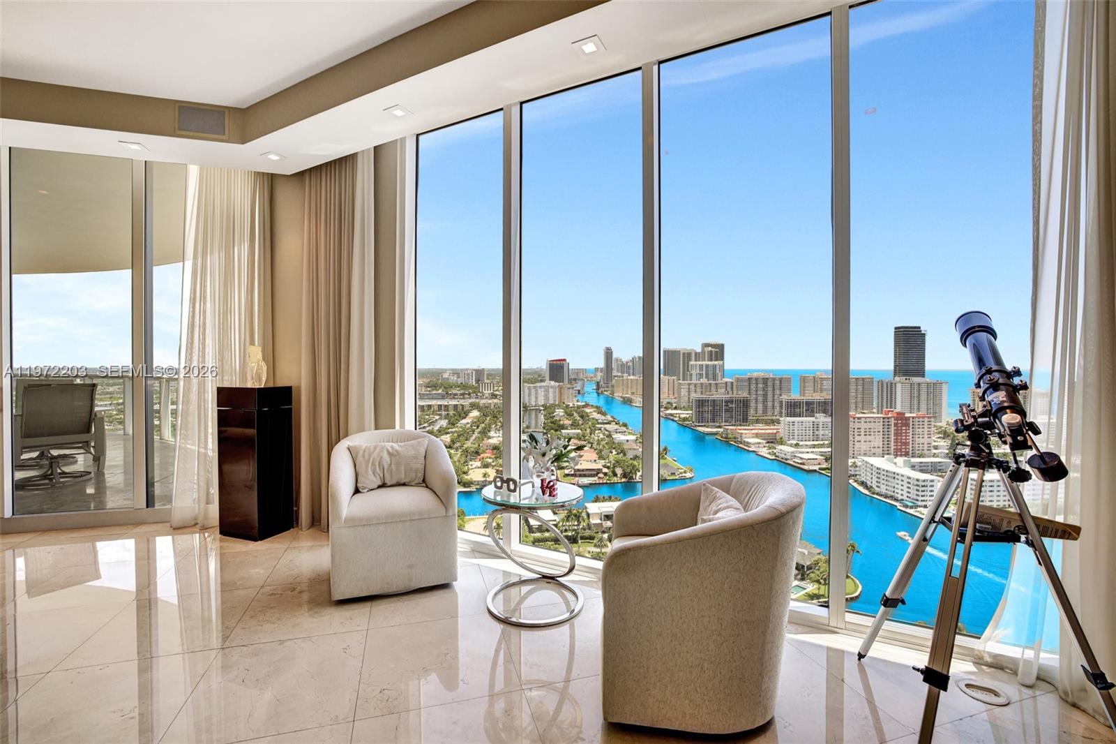 Wow! Welcome To The Epitome Of Luxury In This Extraordinary Penthouse In Atlantic One At The Point. This stunning 3 bedroom, 3.5 bathroom palace in the sky boasts roughly 3,173 square feet of living space. Enter from private elevator and be greeted by high ceilings into a stunning space illuminated by natural light. Enjoy panoramic views of the ocean, Intracoastal, and city skylines from two large terraces. This Penthouse has been renovated to include the finest finishes, including all impact glass windows, electric shades, LED lighting, marble floors, color changing light up Onyx bar, Italian glass doors, and a state-of-the-art redone kitchen with Subzero, Wine Cooler, etc. The primary suite is spacious and features a redone bathroom.
This property is perfect for those seeking a luxurious lifestyle in a prime location. Enjoy the resort lifestyle that only The Point can offer. The community features a renovated 25,000 square foot resident's club, juice bar, gym, spa, four tennis courts, three pools, BBQ area, kids' playground, and more. Seller Financing Available!