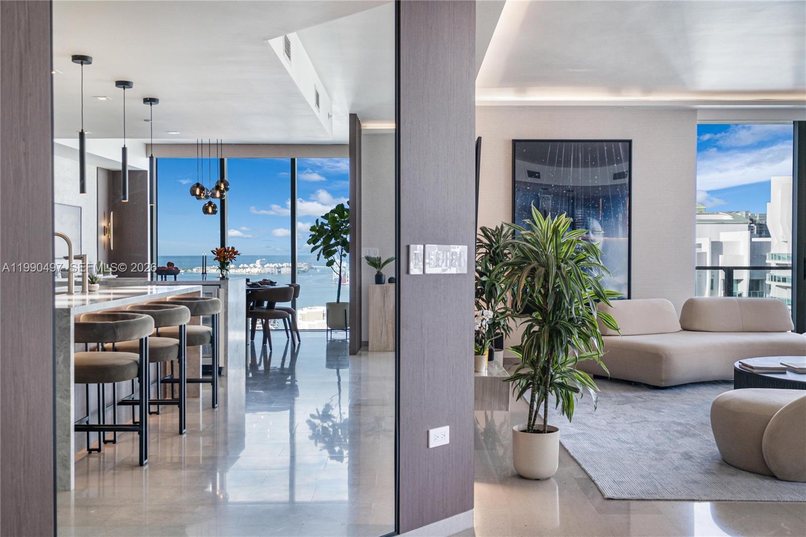 Stunning double-corner residence at Reach at Brickell City Centre with a masterfully upgraded interior. This spacious 3-bedroom, 4.5-bath home plus service quarters features two wraparound terraces with panoramic skyline, river, and bay views. Interior upgrades include complete smart-home capability, custom Italian kitchen cabinetry, new kitchen and bathroom finishes, Miele appliances, custom ambient lighting, electric shades, complete new wall finishes including wood and plaster accent walls, designer wallpaper, and custom built-out closets. Includes 2 assigned parking spaces and 24h valet for guests. Enjoy 5-star amenities including 24-hour concierge and doorman, fitness center, pool & spa, children’s room, and direct access to Brickell City Centre’s world-class shopping and dining.