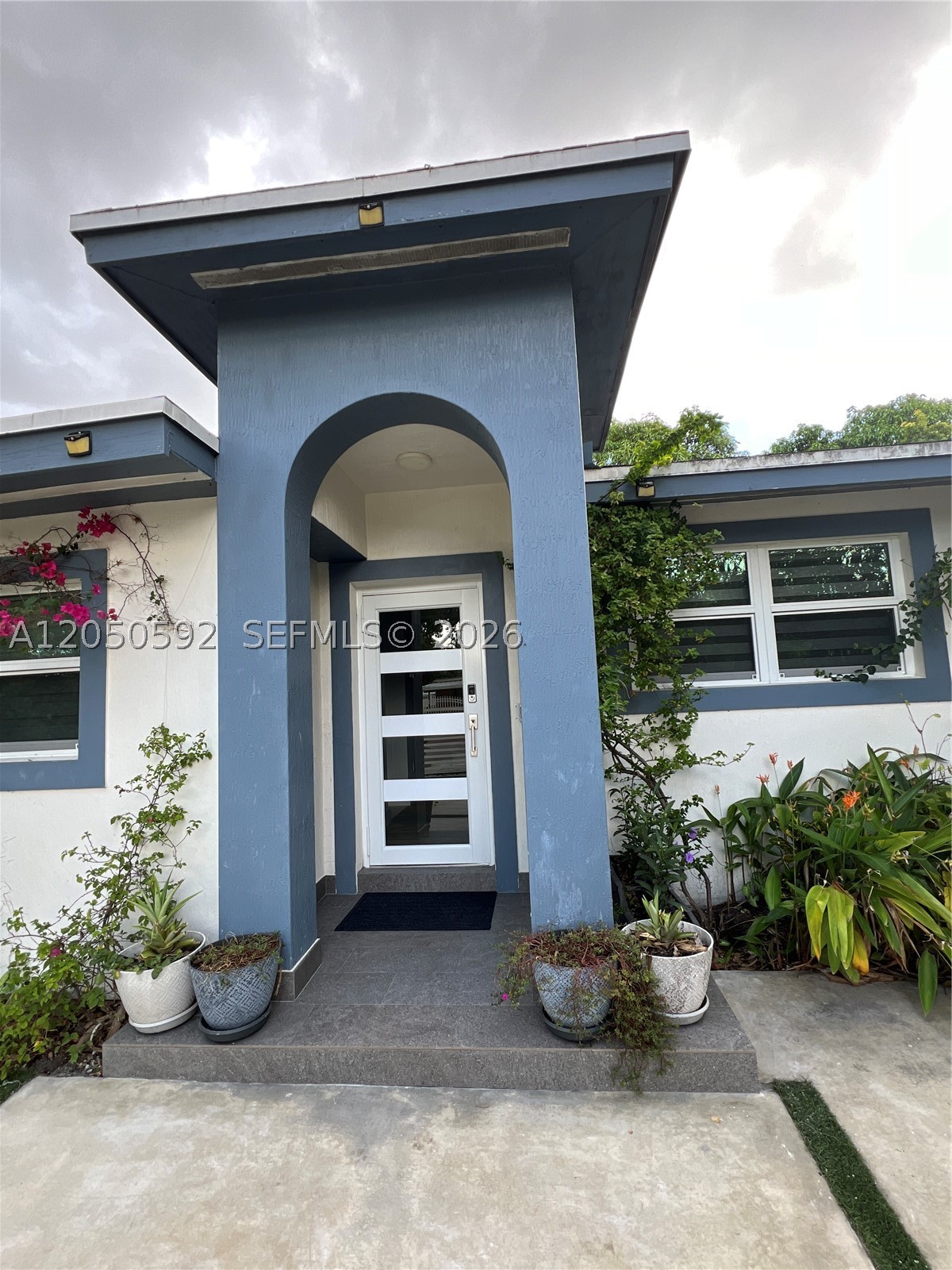 Discover this beautifully renovated, fully furnished home, thoughtfully redesigned with elegant Italian-inspired finishes that blend timeless style with modern comfort. From the custom kitchen and designer fixtures to the upgraded flooring, every space reflects quality craftsmanship and attention to detail. The fully gated and fenced property offers privacy, security, and peace of mind in a quiet, desirable neighborhood. Enjoy it as a spacious 4-bedroom, 3-bathroom home or configure it as a 2-bedroom, 2-bathroom main residence with a private 1-bedroom, 1-bathroom guest suite featuring its own entrance, kitchen, and living room—ideal for rental income, guests, or extended family. Additional highlights include impact windows and doors, a security system with 13 interior and exterior cameras recording 24/7, accessible from your phone or laptop anywhere in the world, an outdoor laundry room with storage, and custom-built sheds on concrete foundations. All furniture and wall art, including many signed by well-known artists, are included. The spacious yard is perfect for relaxing or entertaining. All improvements were completed with permits. Priced to sell and easy to show. Schedule your private tour today!
