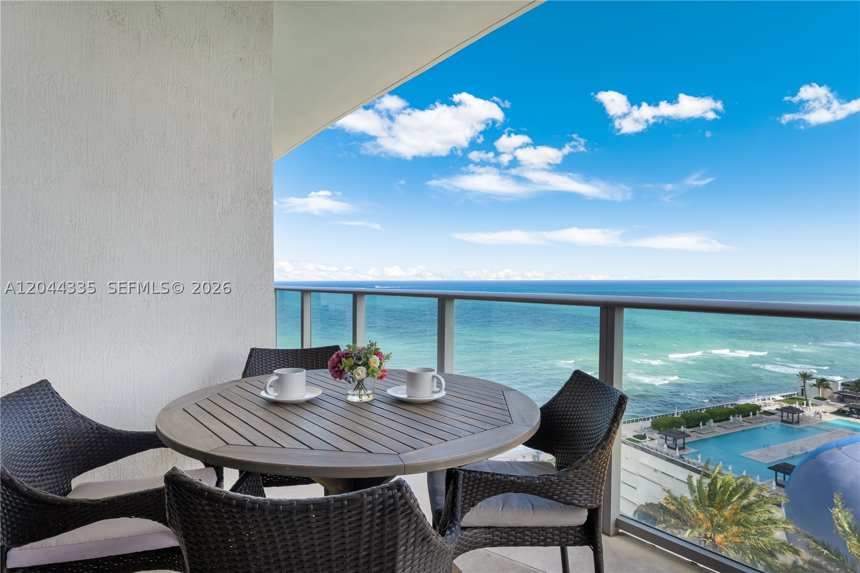 Enjoy resort living in this stunning and spacious beachfront residence located in a modern full-amenity building.  Walk through the front door and be awed by the expanse of the ocean view and the sweeping veranda on which to enjoy it.  All new furniture graces the veranda:  an outdoor dining room adjoins the living room, while outdoor lounge areas adjoin each of the 2 large ensuite bedrooms. The main living area includes a large open concept kitchen that flows seamlessly into the dining and living room.  The dining room features brand new modern furniture, with seating for 4 at the table and an additional 2 at the kitchen island.  Fully furnished, with an in unit washer and dryer, too, this opportunity is completely turnkey.

The Lyfe resort has world class amenities, including beach service, ocean front pool, state of the art fitness center, spa, gourmet and casual dining, 24-hour security, concierge service, and valet parking.  With short term rentals, including AirBnB, allowed, this presents an exceptional investment opportunity, while also providing a personal luxury escape.