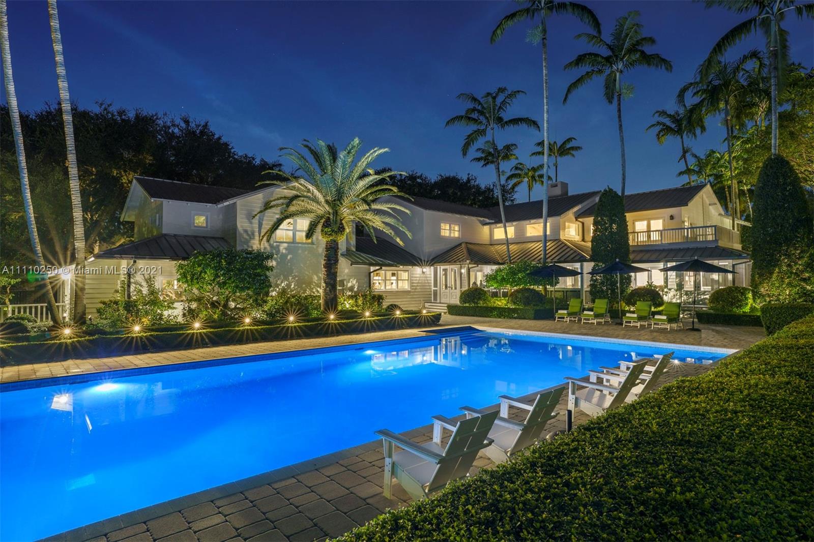 Exquisite Pinecrest estate w/sophisticated Hamptons flair is a designer's masterpiece. Like a page out of Architectural Digest, this 6 bedroom residence and carriage house are renovated to perfection. Highlights include custom millwork & cabinetry, wide-plank oak floors, vaulted open beamed ceilings, full house generator, 3 car garage & more. The elegant foyer entry reveals a graceful staircase, & the light filled living room & dining room are an entertainer's dream. The gourmet kitchen boasts custom cabinetry, 2 Sub-Zero refrigerators, Wolf range, & a large marble island. Serene and luxurious, the primary suite offers every modern comfort. Magnificent landscaping, wraparound veranda perfect for al fresco dining, & heated saltwater pool complete this extraordinary residence.