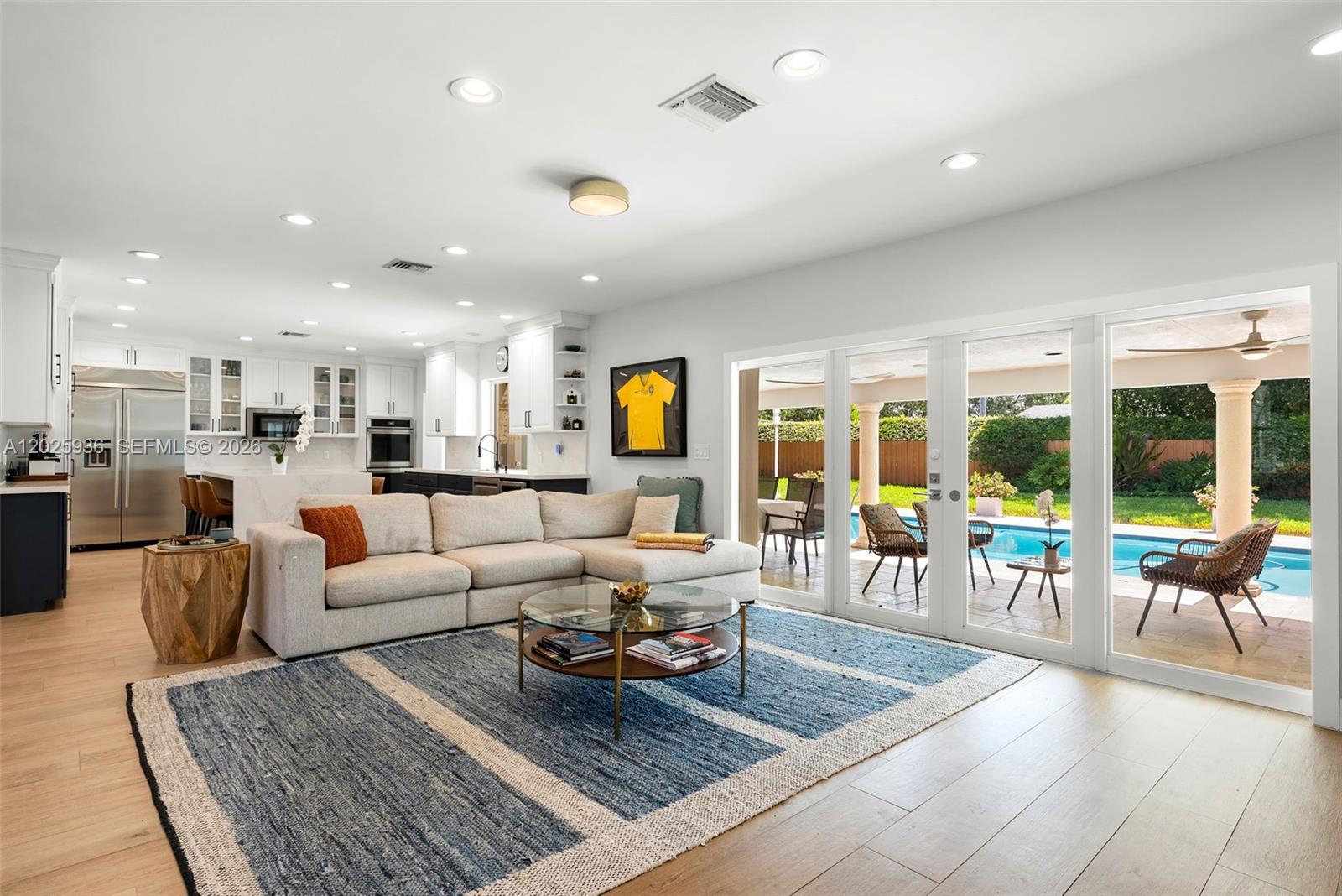 Set on an oversized lot in Palmetto Bay, this beautifully updated 4-bedroom, 2.5-bath residence offers a seamless blend of comfort and thoughtful design. The light-filled open floor plan welcomes you in, with Porcelanosa porcelain flooring throughout and inviting living spaces designed for both comfortable everyday living and effortless entertaining. The open kitchen features a new large island with quartz countertops, while French impact doors open to the covered patio, extending the living spaces outdoors. All four bedrooms are positioned along one private wing, offering both privacy and functionality. The expansive primary suite serves as a peaceful retreat, complete with a spacious bathroom, double walk-in closets, and serene views of the patio and pool. Bathrooms throughout the home have been tastefully renovated with a refined, modern feel. Thoughtfully upgraded over time, the home includes a 2024 roof, one new A/C system and ducts, impact windows and doors along the rear of the home, plantation shutters, and an outdoor camera system. A 2-car garage and a dedicated laundry room with storage add daily convenience. An exceptional backyard and covered patio provide the perfect setting for quiet mornings or weekend gatherings, all set on a high-elevation lot in Flood Zone X. Ideally located near Coral Reef Park, top-rated public and private schools, the Deering Estate, and a variety of everyday essentials, this home offers a lifestyle defined by both ease and connection.
