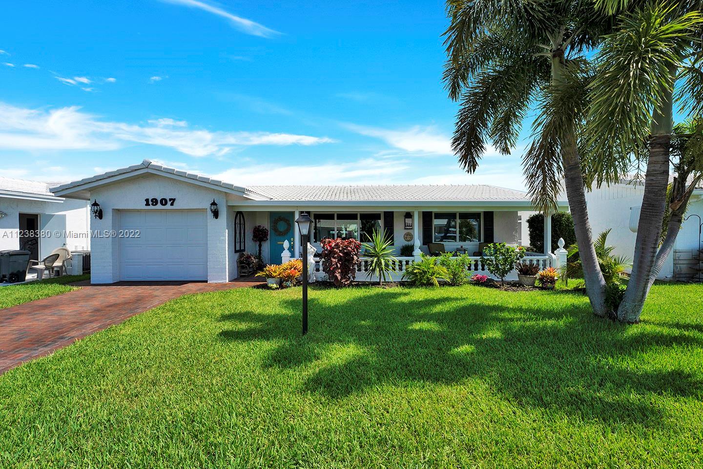 Remodeled 2/2 is ready to move in! Beautiful property features a new roof (2019), new a/c (2020), new impact windows, two outdoor covered porches, redone kitchen, remodeled baths, accordian shutters for patio doors... no expense spared! Favorable SE exposure and unbeatable location - close to golf, major highways, beach, hospitals, restaurants and so much more. Make this your home today!