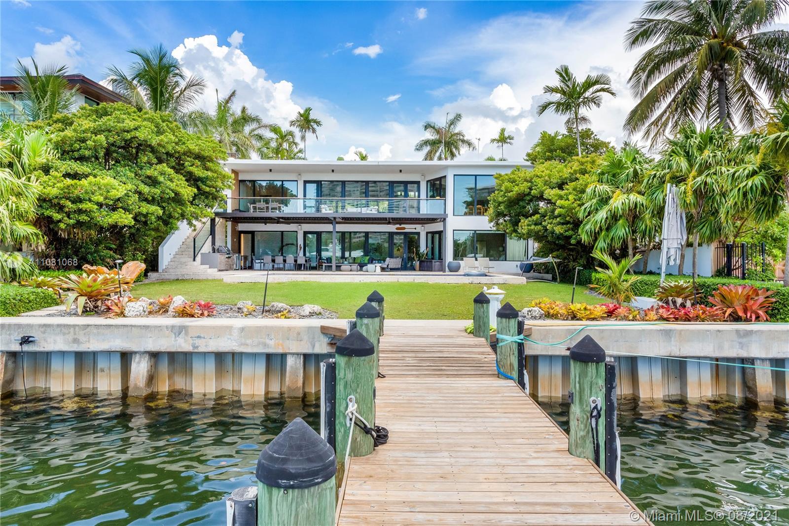 Completely redesigned in 2016, this spectacular modern home in Coconut Grove features 85 ft. of gorgeous waterfront. Expansive windows and doors let in natural light showcasing views of Biscayne Bay. Great for entertaining, the home features a heated saltwater pool, generator, summer kitchen and indoor/outdoor spaces overlooking the water. Helping define the striking home are designer finishes such as Oak wood and basalt stone countertops. This modern house exploits the best views on the second floor for the living areas and give residents on the ground level easy access to pool and dock. Excellent location near parks, shopping, dining and entertainment.