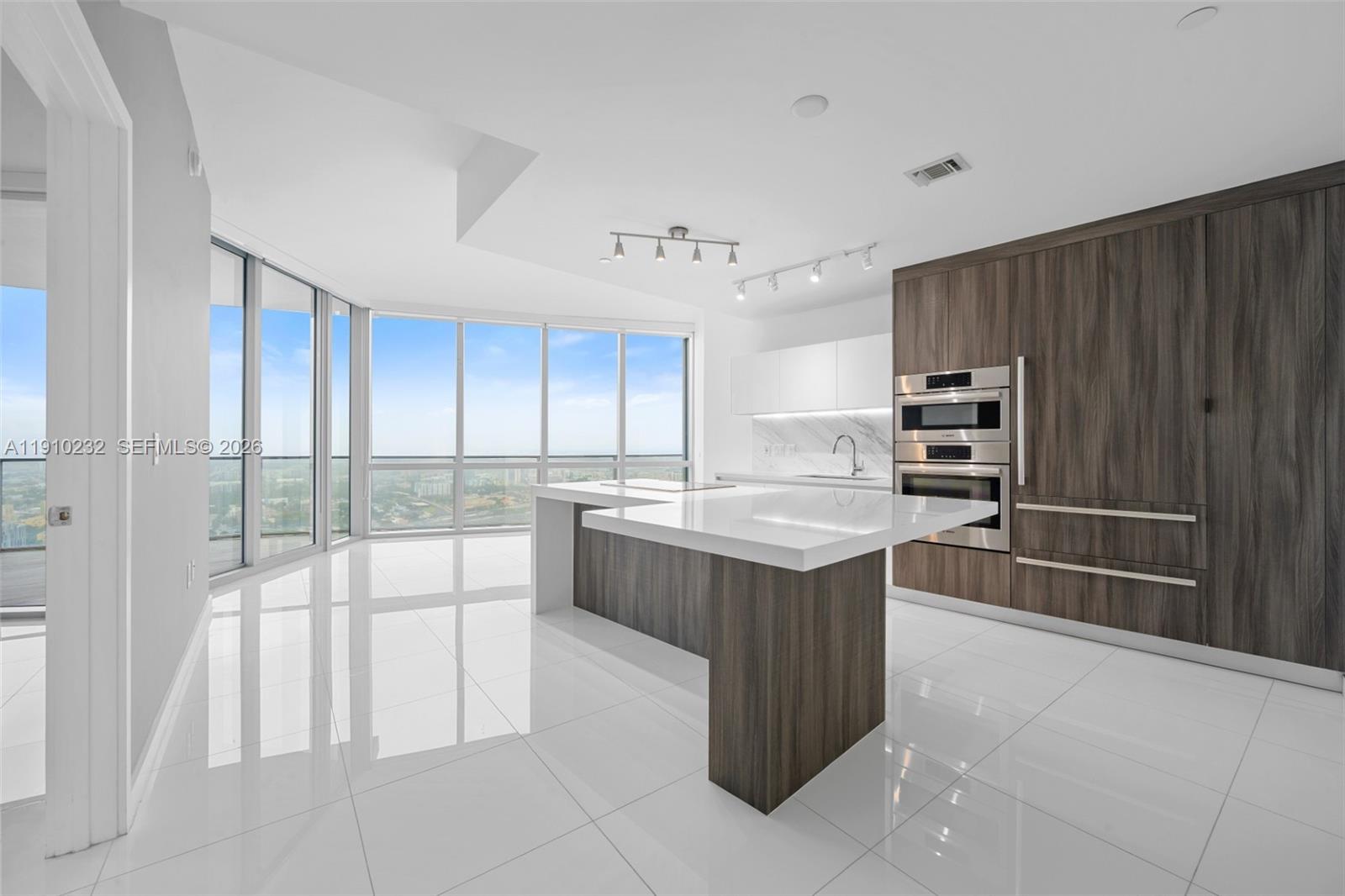Experience elevated living at Paramount Miami Worldcenter, the tower celebrated as ‘the building with the most amenities in the world.’ This never-lived-in residence features a spacious 1-bedroom plus DEN with 2 full bathrooms, with the DEN easily adaptable as a second bedroom. Step off your private elevator into a grand foyer that opens to a bright, open-concept living space and a large dine-in terrace showcasing spectacular city and sunset views. The Snaidero Italian kitchen is outfitted with top-of-the-line Bosch appliances and quartz countertops, while 10-foot ceilings, floor-to-ceiling impact glass, and porcelain flooring throughout create a sense of modern elegance. The primary suite offers a spa-inspired marble bathroom, and the home includes a full-size washer and dryer for convenience.