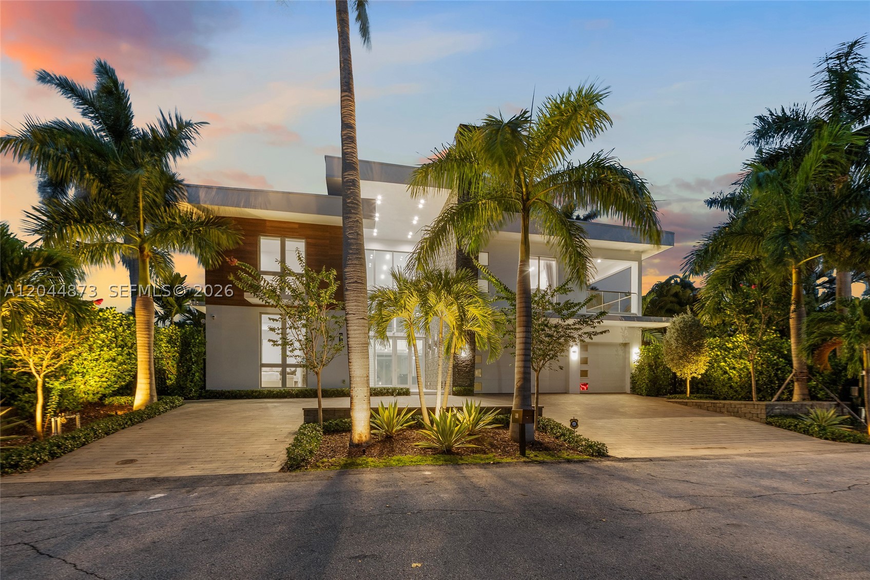 Modern waterfront luxury reaches new heights in this exceptional new construction estate, perfectly positioned on 85 feet of deepwater frontage in prestigious Las Olas Isles. Showcasing sleek architectural lines, expansive walls of glass, and breathtaking water views from nearly every major room, this magnificent residence offers 8,116 total square feet of sophisticated living space designed for the ultimate South Florida lifestyle. A dramatic two-story foyer creates an unforgettable first impression, opening to light-filled living spaces that seamlessly connect to the waterfront. The floor plan features a private elevator, grand living room, formal waterside dining room, and a chef's kitchen with premium Miele appliances, custom cabinetry, and designer finishes.
Designed for entertaining and relaxation, the first level includes an intimate club room with book-matched stone walls, rich wood paneling, and oversized porcelain tile flooring. Expansive glass doors open to covered outdoor living areas and resort-style waterfront amenities. Upstairs, white oak flooring and integrated LED lighting lead to a primary suite with a spa-inspired bath, freestanding tub, custom finishes, and private terrace. Four additional VIP guest suites provide luxurious accommodations, while a sunset-facing terrace and covered second-floor patio showcase panoramic water views. This seven-bedroom modern masterpiece blends contemporary elegance, exceptional craftsmanship, and premier waterfront living.