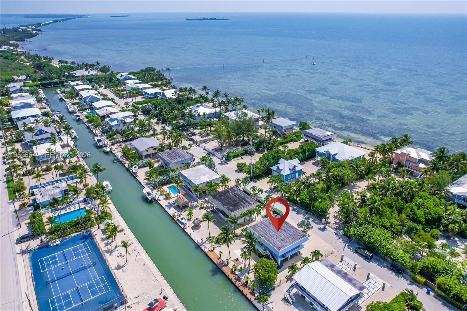 Seller will consider seller financing. Florida Keys waterfront home, offered fully furnished, 1,786 SqFt living area (larger than tax roll) fully renovated 3 bedroom, 3 bath waterfront property situated in Lower Matecumbe Key with 7,500 SQ FT lot with the plus of no home owners association. Seawall was completed & elevated in 2021. Boaters paradise w/75FT of dockage, under 5 minute ride to open ocean + easy access to bay as well, plenty of space to install a boat lift. There is also a private neighborhood concrete boat ramp that can be used by the neighbors on this street. Canal depth is estimated 10-12 FT. Unique layout offers 2 bedrooms & 2 baths on the second floor with full kitchen & spacious living room area, washer & dryer. First floor offers 1 bedroom & 1 bath, washer & dryer, full kitchen (separate living units). New roof/hurricane impact windows. Easy storage space. Ample parking.
